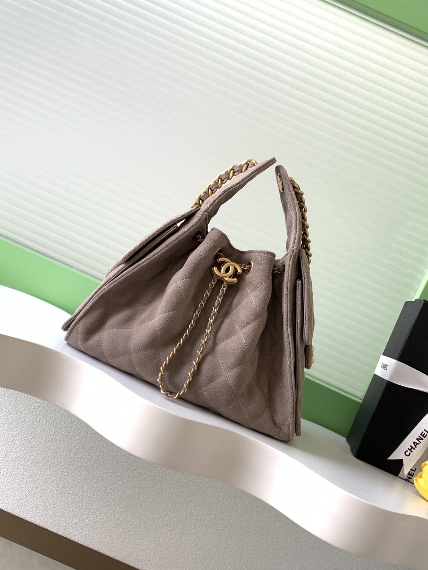 Elegant Quilted Drawstring Bucket Bag with Chain Accent, Timeless Design