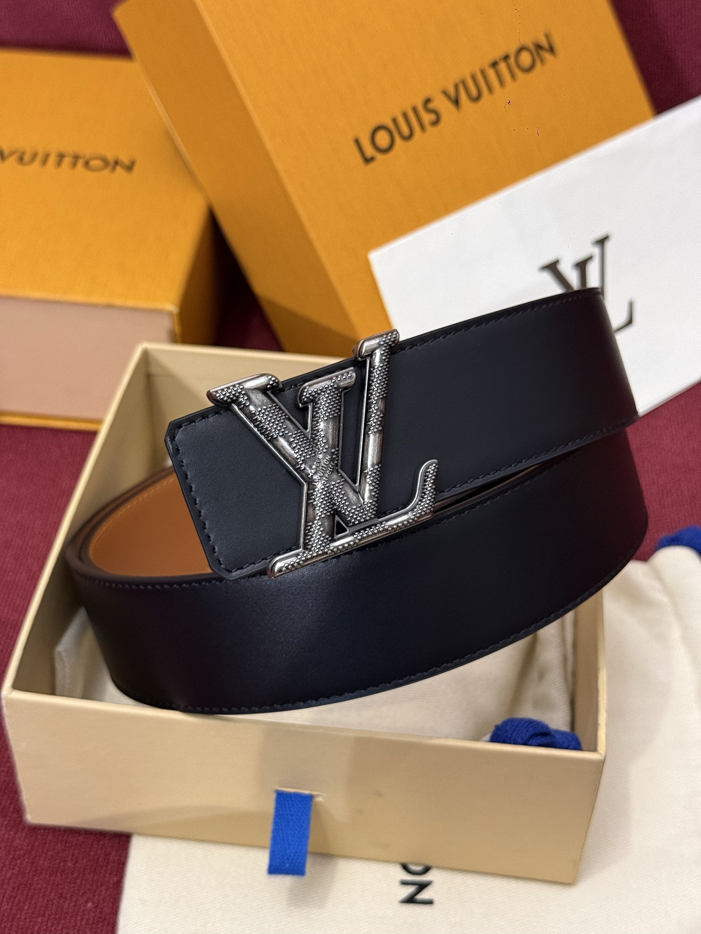 本款 Damier LV 40 毫米双面腰带做工精良，风格经典。深色牛皮革皮带与 LV 字母搭扣优雅相称