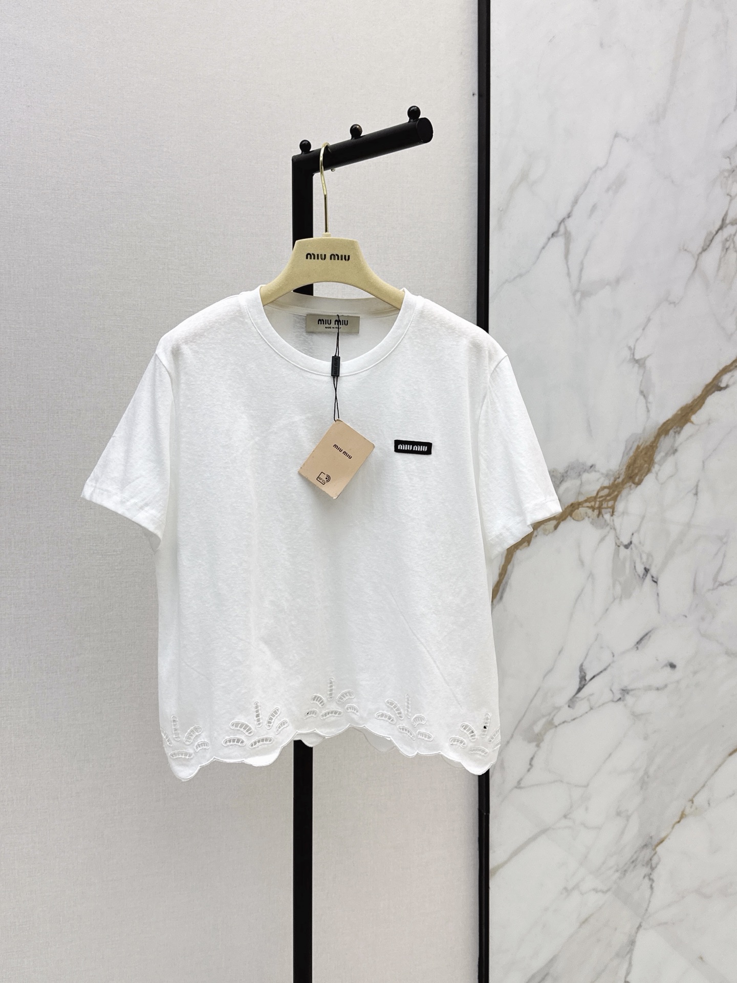 NO:876780,Miu 26Ss————The latest spring and summer short T-shirt with hem embroidery design is made of 100% cotton fabric. It is soft and skin-friendly and breathable. It is super comfortable to wear in summer. It has letter embroidery on the chest and a hollow lace design on the hem. It is full of details. It is elegant and versatile. The loose version looks slim and comfortable. It can be worn for daily commuting and leisure. It looks great with trousers or jeans. It is easy to get a minimalist style outfit.  One color ready for sale sml,,miumiu,jeans,tees,t-shirt,19860909Miu 26Ss————春夏最新款下摆刺绣设计短款T恤采用全棉面料 柔软亲肤又透气 夏天穿超舒服 胸前字母刺绣 下摆镂空花边设计 细节满满 优雅又百搭 宽松版型显瘦又自在 日常通勤休闲都能穿 搭配西裤或牛仔裤都很出彩 轻松get极简风穿搭 一色现货发售sml,,miumiu,jeans,tees，t-shirt,,Women's clothing