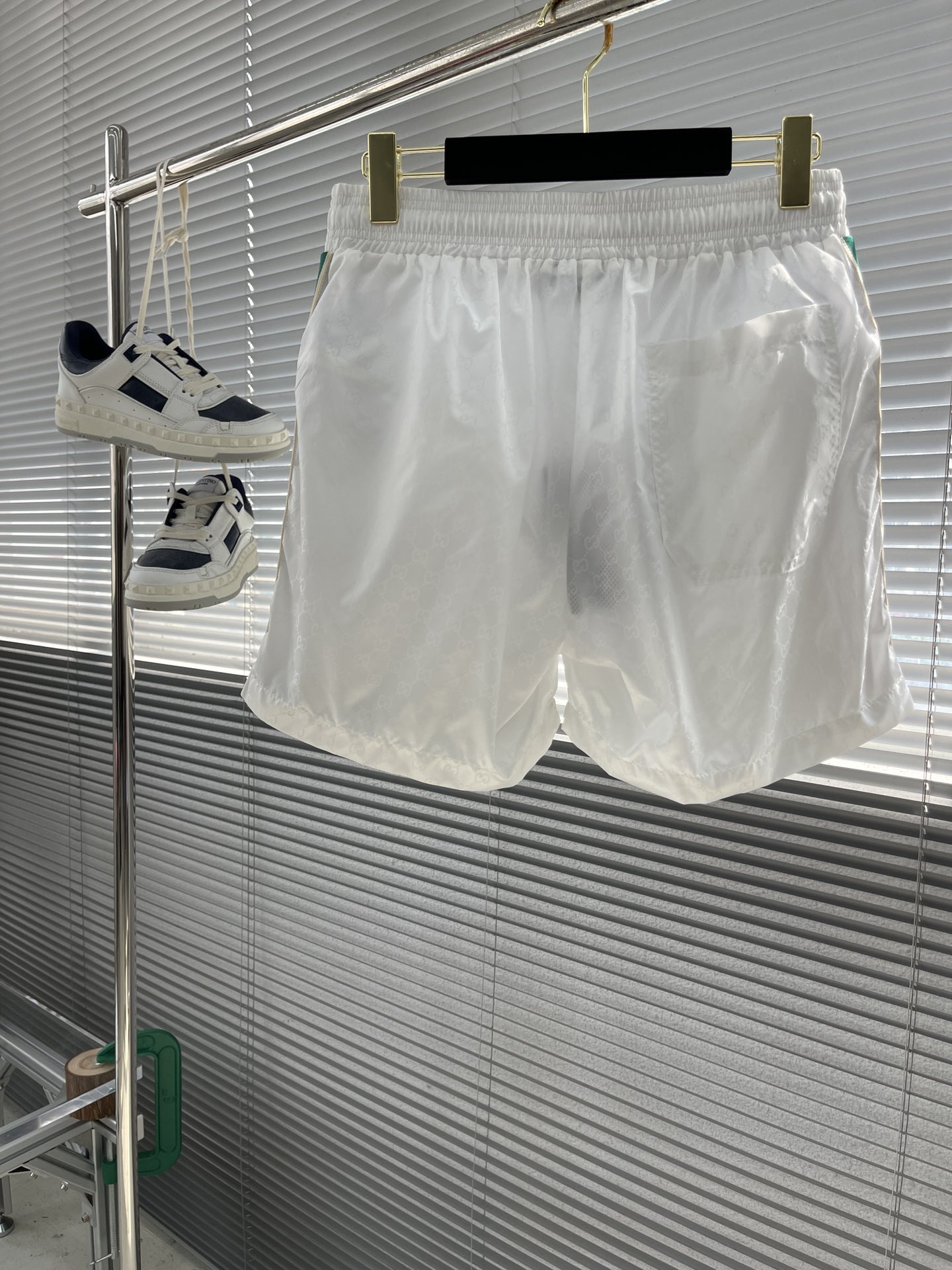 -GUCC 彩边休闲沙滩短裤，这款短裤采用双GG提花面料制作，腰头有松紧腰绳，两个口袋配有拉链，裤腿侧边