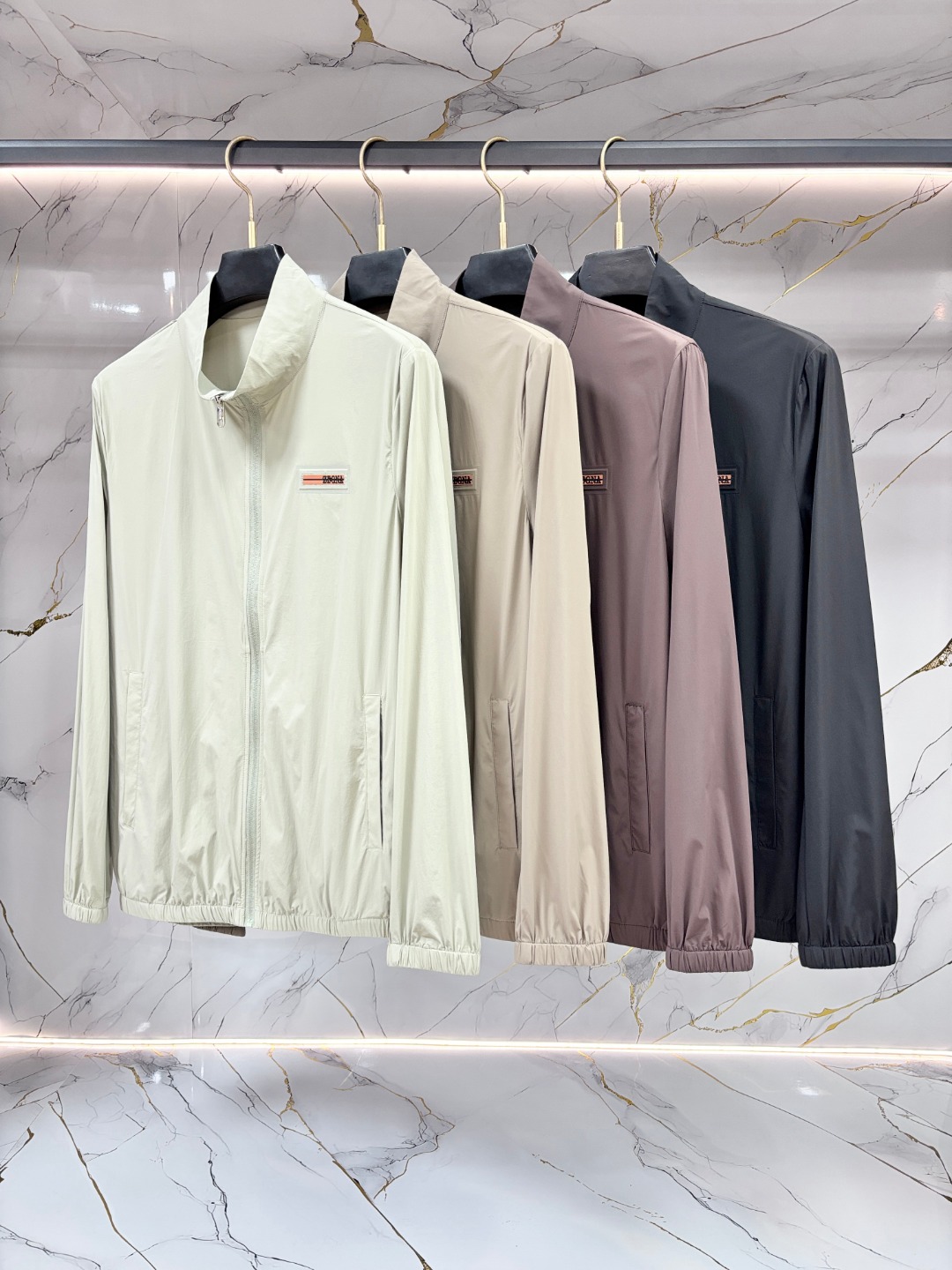 NO:903583,Zegna's new spring and summer men's sun protection clothing is a lightweight jacket. It is made of uniquely customized sun protection four-way elastic fabric. It has excellent elasticity and resilience and four-way stretch. The fabric is elastic in the warp and weft, transverse, longitudinal and diagonal directions. It can adapt to a wide range of physical activities, such as exercise, squatting and is not easily deformed.  The use of elastic fiber blending technology ensures that it can quickly return to its original shape after repeated stretching to avoid looseness and bulging. It is comfortable and fit without any sense of restraint. It is adaptive tailoring and can naturally fit the body curve without relying on complicated version design. It is light and breathable, and has high-density weaving or microporous structure technology.  , taking into account elasticity and breathability, reducing the feeling of stuffiness, and suitable for long-term wear. It has high strength and wear resistance, long service life, and tear resistance. Through the scientific ratio of polyester fiber, nylon and elastic fiber, the fabric's anti-friction and anti-snagging properties are improved, especially suitable for outdoor sports or high-frequency use scenarios.  It is washable and durable. The high-quality four-way stretch fabric has been treated with anti-pilling, anti-static and other post-finishing processes. It can still maintain elasticity and color stability after repeated machine washing. It improves the comfort of daily wear and has a high skin-friendly feel. The elastic woven structure balances elasticity and fabric stiffness.  Post-finishing technology, sanding, moisture-wicking coating, anti-UV treatment, etc., expand functional applicability, such as sun-proof four-way stretch jackets. Four-way stretch fabrics have become the preferred material for sports, leisure, and functional clothing due to their all-round elasticity, long-lasting durability, and wide applicability. At the same time, they continue to expand their combination in the fields of fashion and technology through process innovation. Zipper pockets are convenient for storing small items; cuff elastic adjustment and hem drawstrings enhance the fit and prevent the coat from shifting during activities.  It is both fashionable and practical, simple and versatile, neatly cut, and available in solid color, gradient color or contrasting color design to meet daily commuting!  Size M-3XL,,zegna,jackets & coats,19860909Zegna 杰尼亚 春夏新款男士防晒服轻薄外套,独特订制防晒四面弹面料,卓越的弹性与回弹性,四向拉伸,面料在经纬,横向与纵向及对角线方向均具备弹性,适应大幅度的身体活动,如运动、蹲坐且不易变形. 采用弹性纤维混纺工艺,确保多次拉伸后仍能快速恢复原状,避免松弛、鼓包,舒适贴合,无束缚感,自适应剪裁,无需依赖复杂版型设计,即可自然贴合身体曲线,轻薄透气,高密度编织或微孔结构工艺,兼顾弹性与透气性,减少闷热感,适合长时间穿着.高强耐磨,使用寿命长,抗撕裂性,通过聚酯纤维、锦纶与弹性纤维的科学配比,提升面料抗摩擦、抗勾丝性能,尤其适合户外运动或高频使用场景. 耐洗耐穿,优质四面弹面料经防起球、抗静电等后整理工艺处理,反复机洗后仍能保持弹性和色泽稳定性.提升日常穿着的舒适度高重亲肤感,弹力梭织结构,平衡弹性与面料挺括度. 后整理技术,磨毛、吸湿排汗涂层、防紫外线处理等,扩展功能适用性,如防晒四面弹外套,四面弹面料凭借全方位的弹性、持久的耐用性及广泛的适用性,成为运动、休闲、功能性服饰的首选材质,同时通过工艺创新不断拓展其在时尚与科技领域的结合.拉链口袋方便存放小物；袖口松紧调节、下摆抽绳增强贴合性,防止活动时外套移位. 时尚与实用兼备,简约百搭,剪裁利落,提供纯色、渐变色或撞色设计,满足日常通勤！ 码数M-3XL,,zegna,jackets & coats,,Men's clothing
