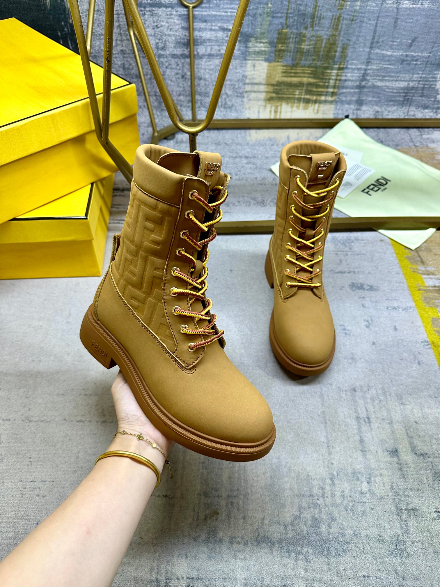 NO:613277,FENDI Filo round-toe lace-up combat boots. Made of light brown waterproof suede, decorated with the signature embossed FF pattern in the same color. Two-tone mountaineering lace closure, decorated with metal eyelets. Gold buckle on the back. Rubber sole, FENDI lettering on the side of the heel. Sizes 35-42, boots, fendi, boots19860909FENDI Filo圆头系带军靴.浅棕色防水绒面皮材质,饰有同色系标志性凸纹FF图案.双色登山鞋带开合,饰金属孔眼.背面饰有金色饰扣.橡胶鞋底,鞋跟侧面饰有FENDI字样.35-42码,,靴子,fendi,boots,Women's Shoes