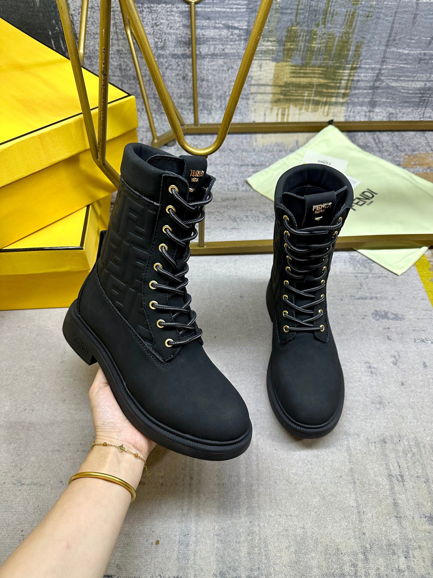NO:613271,FENDI Filo round-toe lace-up combat boots. Made of black waterproof suede, decorated with the signature embossed FF pattern in the same color. Two-tone mountaineering lace closure, decorated with metal eyelets. Gold buckle on the back. Rubber sole, FENDI lettering on the side of the heel. Sizes 35-42, boots, fendi, boots19860909FENDI Filo圆头系带军靴.黑色防水绒面皮材质,饰有同色系标志性凸纹FF图案.双色登山鞋带开合,饰金属孔眼.背面饰有金色饰扣.橡胶鞋底,鞋跟侧面饰有FENDI字样.35-42码,,靴子,fendi,boots,Women's Shoes