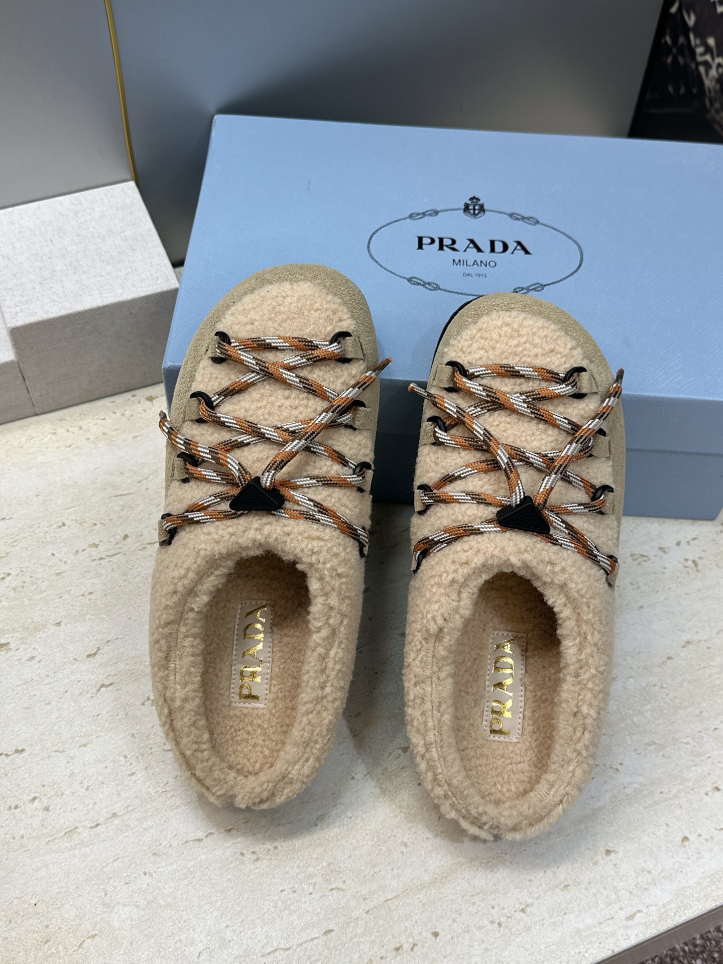 顶级版 Prada 2026秋冬新款羊羔毛系带拼色穆勒女鞋 普拉达字母logo平底圆头防寒保暖拖鞋 材质:鞋面进口羊猄 顶级版 Prada 2026秋冬新款羊羔毛系带拼色穆勒女鞋 普拉达字母logo平底圆头防寒保暖拖鞋 材质:鞋面进口羊猄