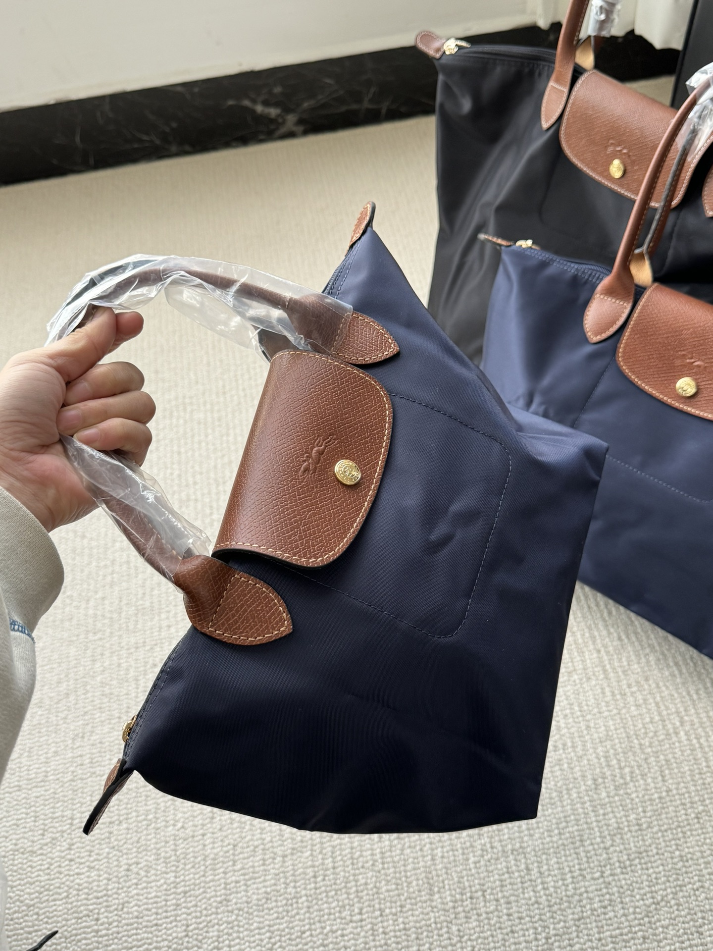 Longchamp ～藏青色大号没入镜，跟黑色对比看下吧，颜色比较低调奢华，这种购物袋实用性 强，我用过我知道，有发言权