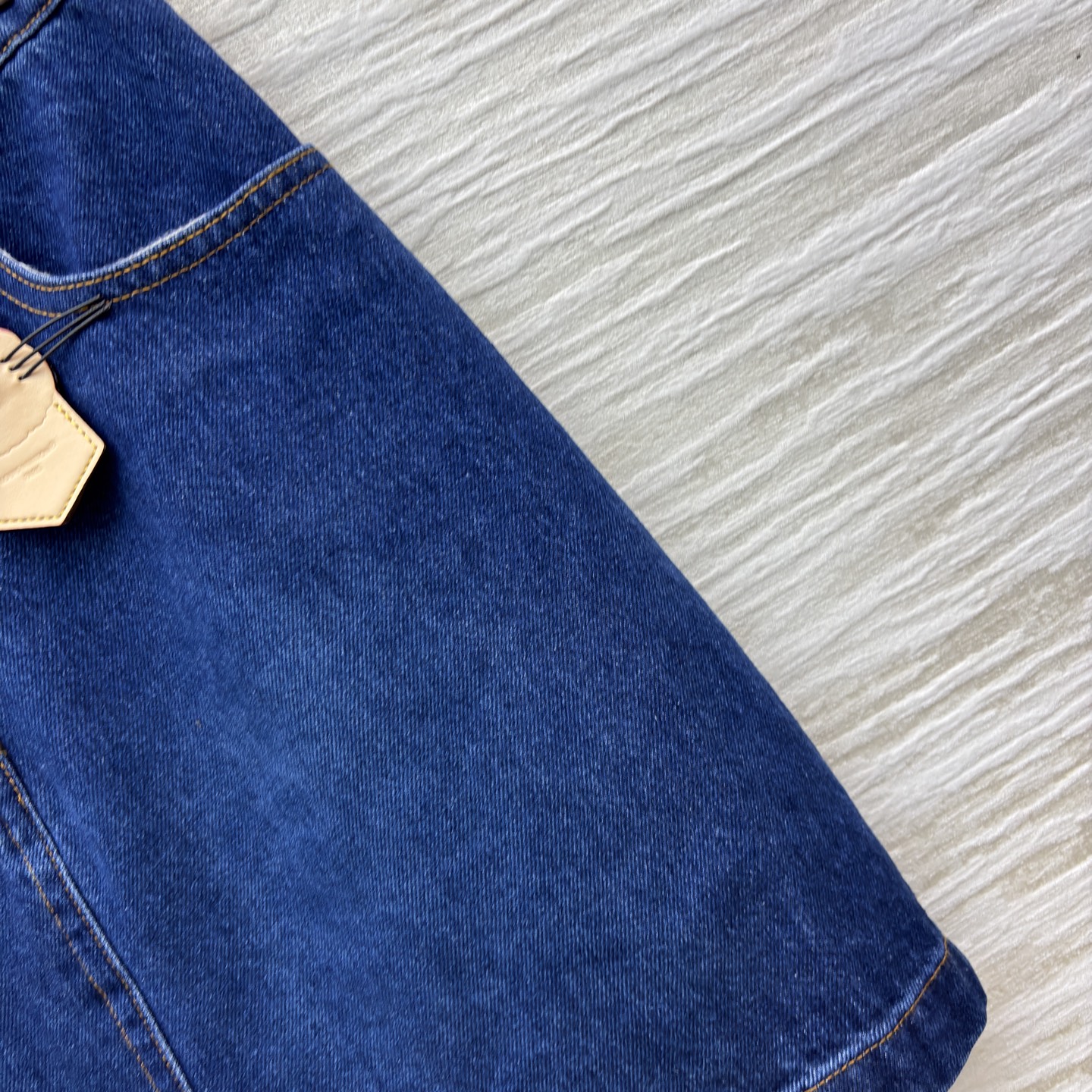 L家25秋冬 猫咪皮牌牛仔系列 经典深蓝色牛仔短裙 版型利落又显活力 搭配精致金属扣与可爱猫咪挂饰 瞬间