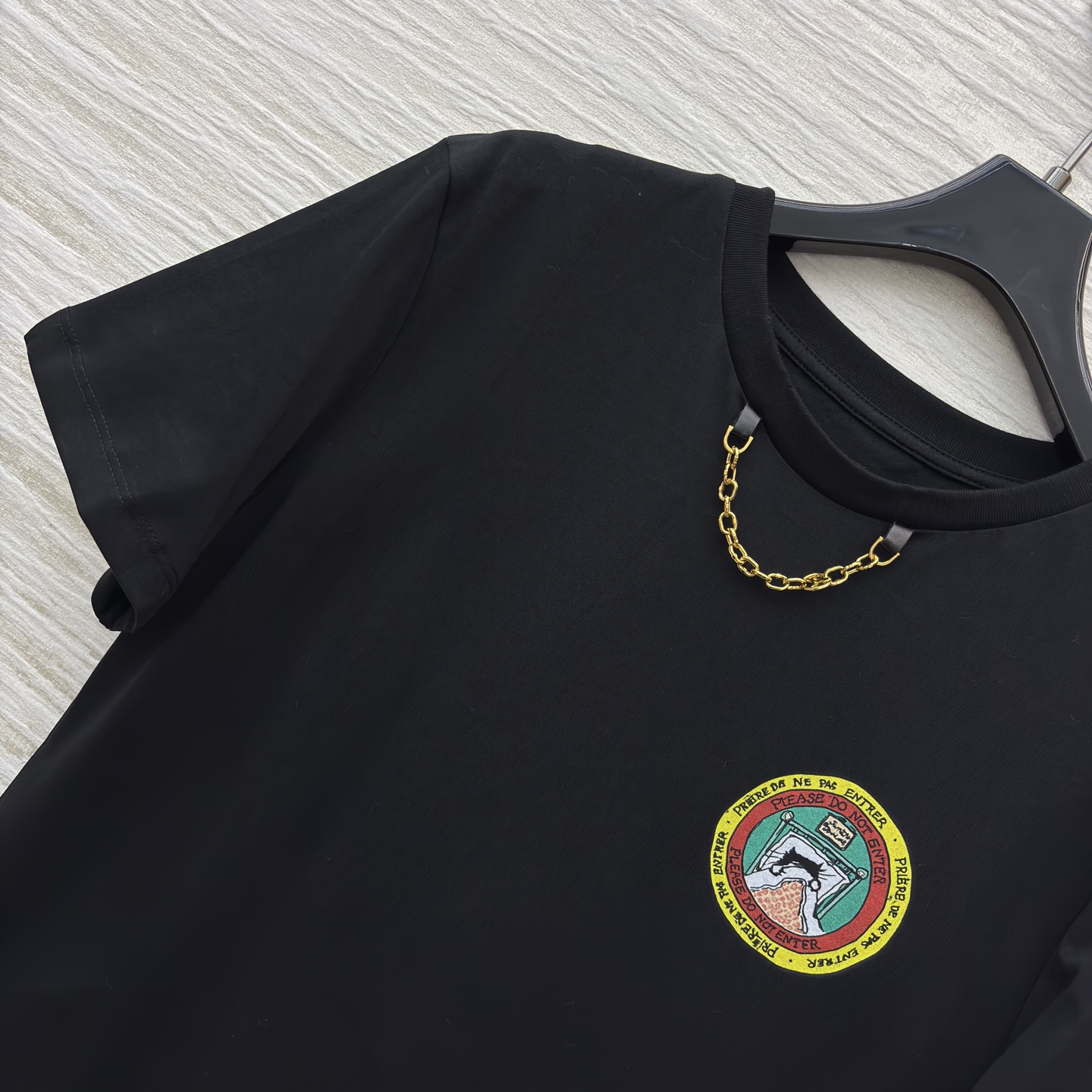 L家 25秋装 猫咪印章 T 恤 设计感拉满 领口金属链点缀+彩色徽章 简约又不失个性 日常搭配牛仔裤或