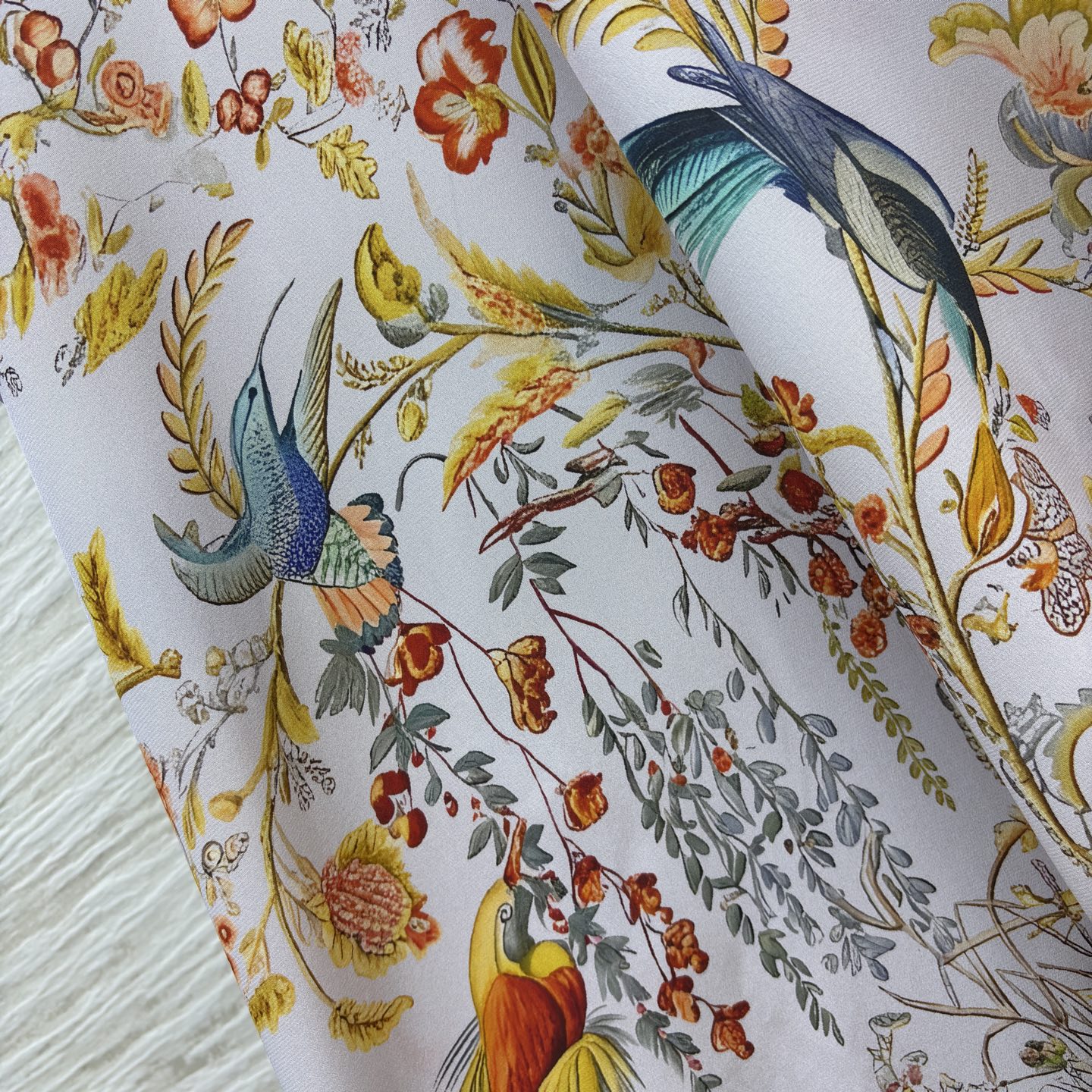 花鸟真丝印花长裙 底色干净柔和 缤纷花鸟图案栩栩如生 领口蝴蝶结设计温婉雅致 斗篷式飞袖飘逸灵动 垂顺的