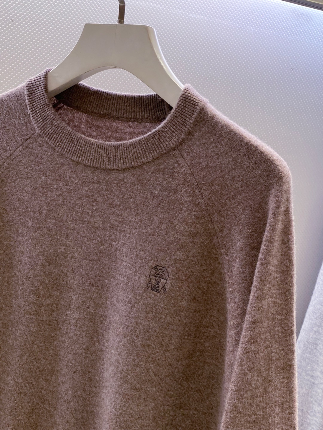 BC~经典logo刺绣叉肩圆领毛衣
秋冬新品
精选高支美丽诺羊毛，把柔软与经典，织进日常质感里&hellip;.触感是肉眼可见的细腻软糯&mdash;&mdash;没有普通羊毛的扎肤感，贴身穿亲肤不刺痒，自带天然的温煦包裹感，既保留羊毛的保暖性，又兼具轻盈透气的特质，秋冬单穿不厚重，叠穿不臃肿。
圆领+叉肩连袖的版型藏着不挑人的包容感！圆领恰到好处不挑脸型更不挑内搭；叉肩袖设计弱化肩线棱角，合身不紧绷的版型，无论是搭任何裤子都能轻松适配。
胸前经典logo刺绣是点睛之笔：没有繁复花样，仅以精致针脚将品牌标识绣于衣身，线条清晰不突兀，既有品牌辨识度又不张扬。整体简约却不简单，把BC一贯的低调优雅藏在羊毛的柔软肌理与经典设计里，日常穿、通勤穿都能透出不经意的质感。

颜色：黑色、驼色、浅灰色
规格：M--XXL
    P310
M码：连肩袖74、胸围110、衣长67
L码：连肩袖75、胸围114、衣长68