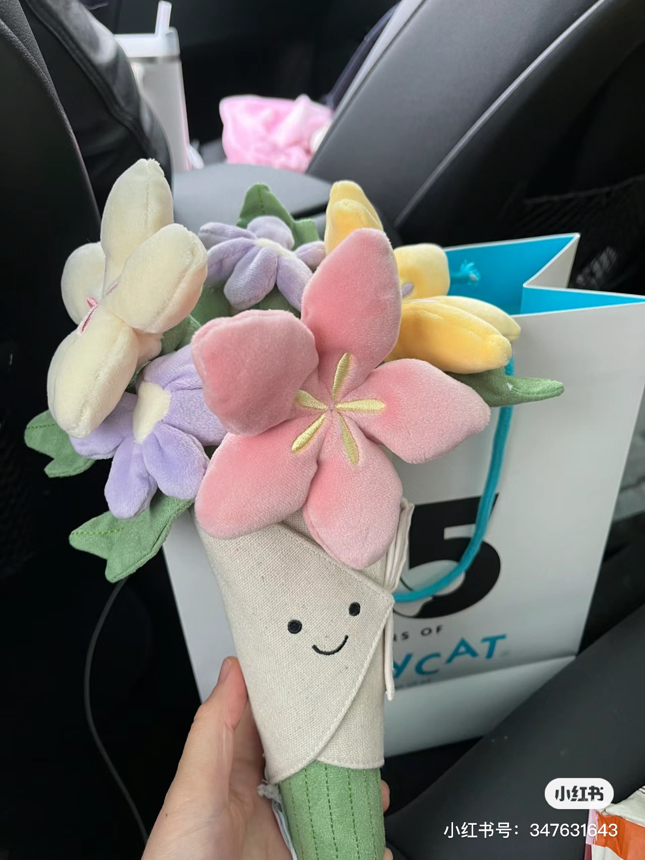 A multi-colored plush floral bouquet featuring a vibrant rainbow candy-i - Comprehensive