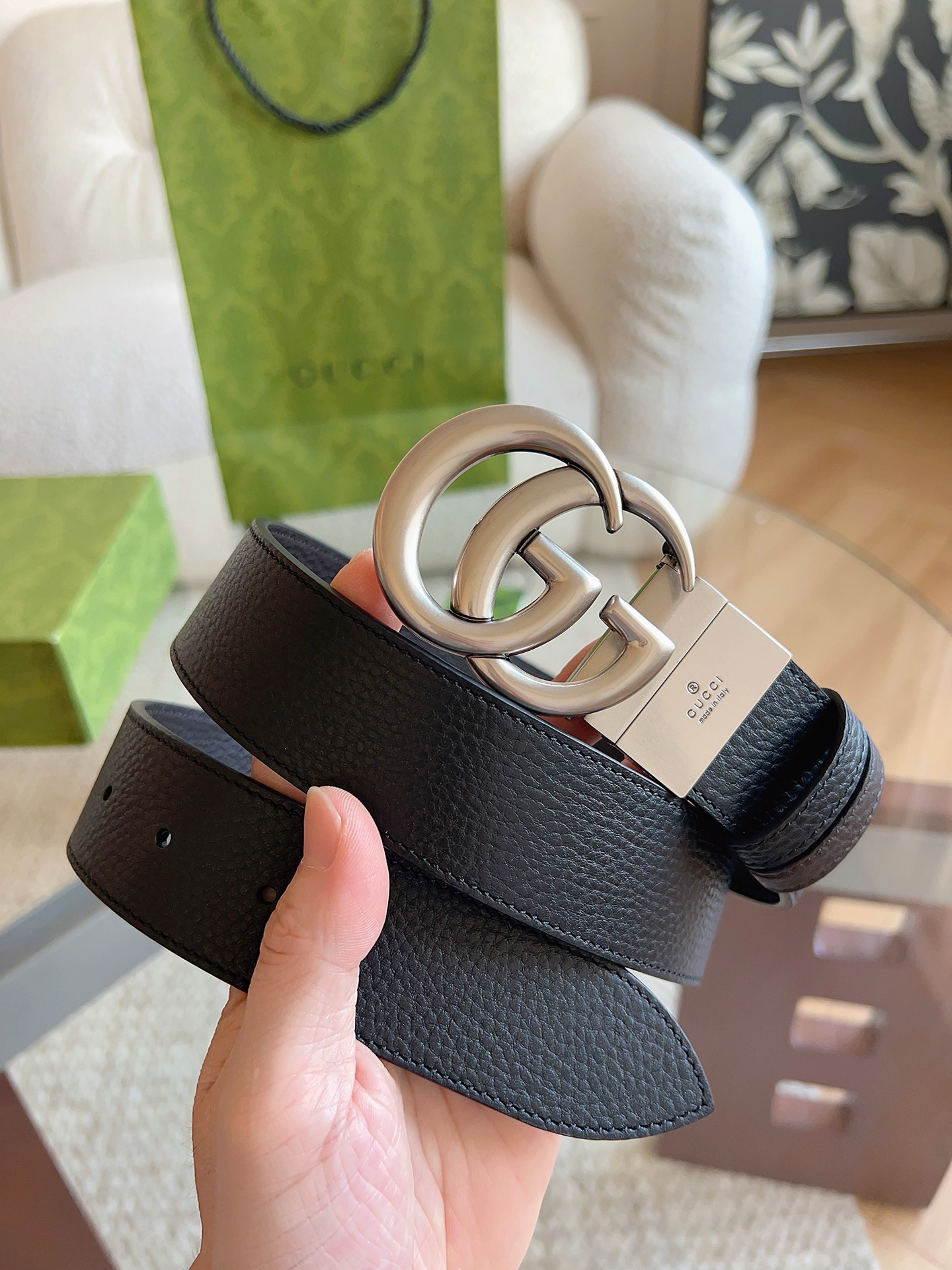 GUCCI 这款双面皮革腰带采用荔枝纹皮革材质，饰以经典双G搭扣，该配件灵感源自品牌辉煌的70年代典藏设