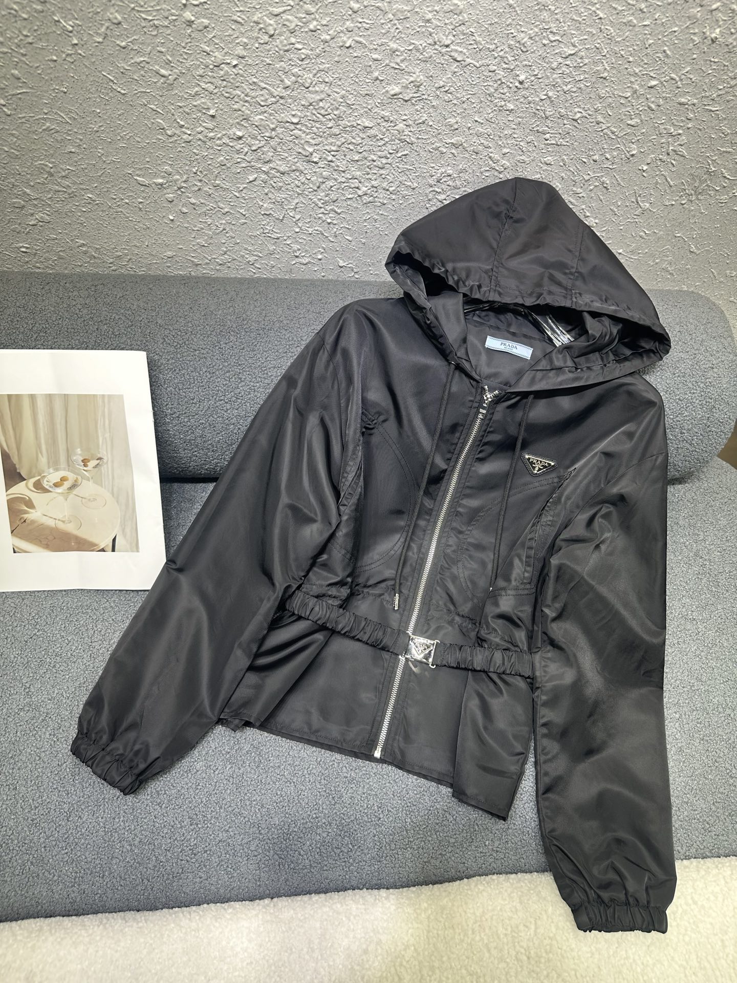 NO:794825,Prada*2026 early spring new hooded jacket. Classic triangle logo decoration on the chest. Matched with a customized belt. The drawstring design at the waist makes the waist slimmer. Nylon fabric is windproof and light. Monochrome SML P,,prada,jackets & coats,hats,19860909Prada*2026早春新款连帽外套 胸前经典三角标装饰 搭配定制腰带 腰部做抽绳设计收腰显瘦 尼龙面料防风轻薄 单色SML P,,prada,jackets & coats,hats,,Women's clothing