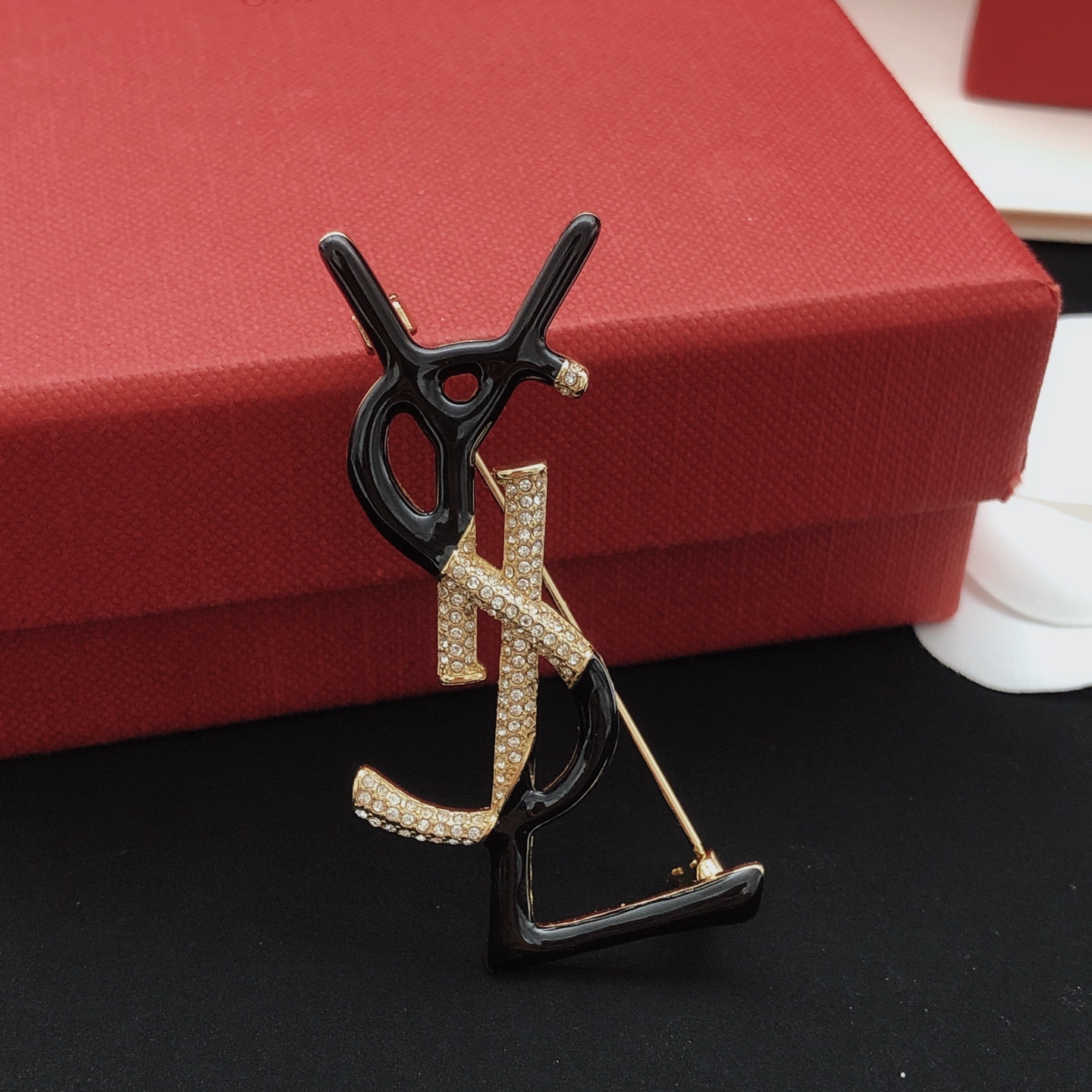 Saint Laurent Cassandre Monogram Brooch brooch gold-tone metal with clear pave crystals available in black enamel and white enamel variants 4 5cm height
