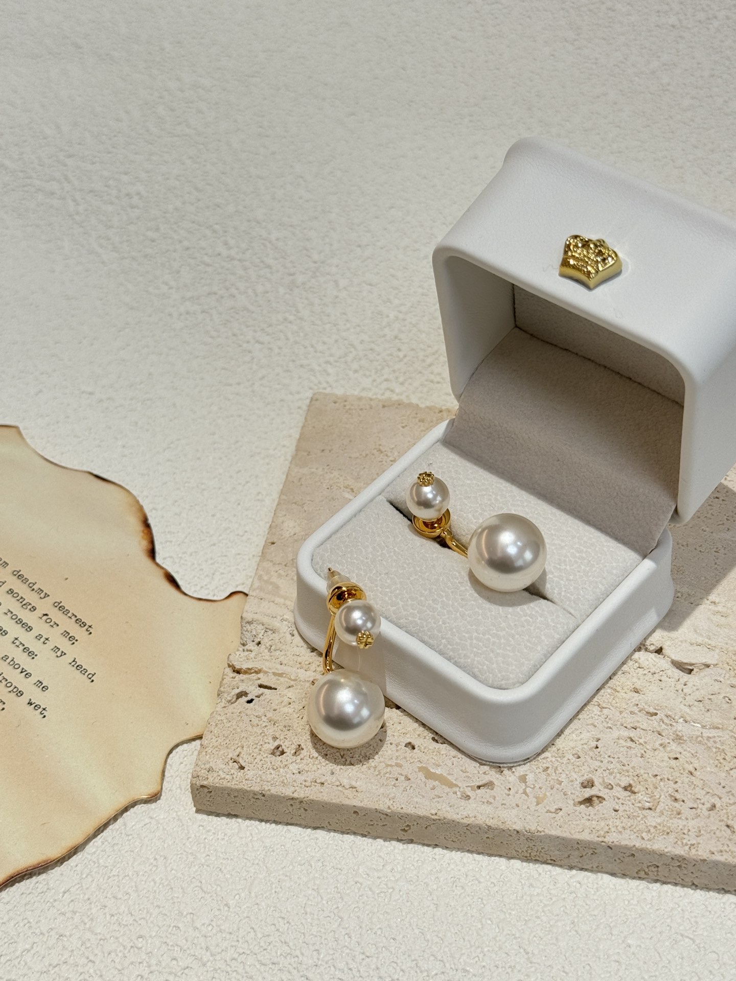 The earring design with two pearls on top and bottom is believed to be - Jewelry 2