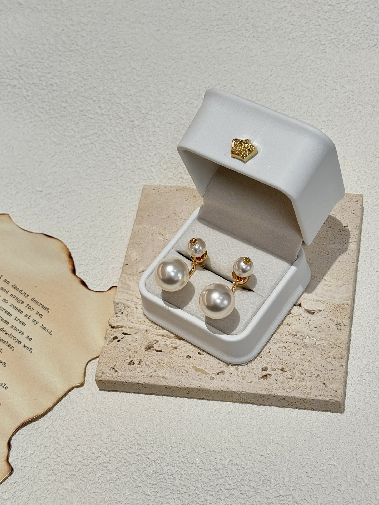 The earring design with two pearls on top and bottom is believed to be - Jewelry