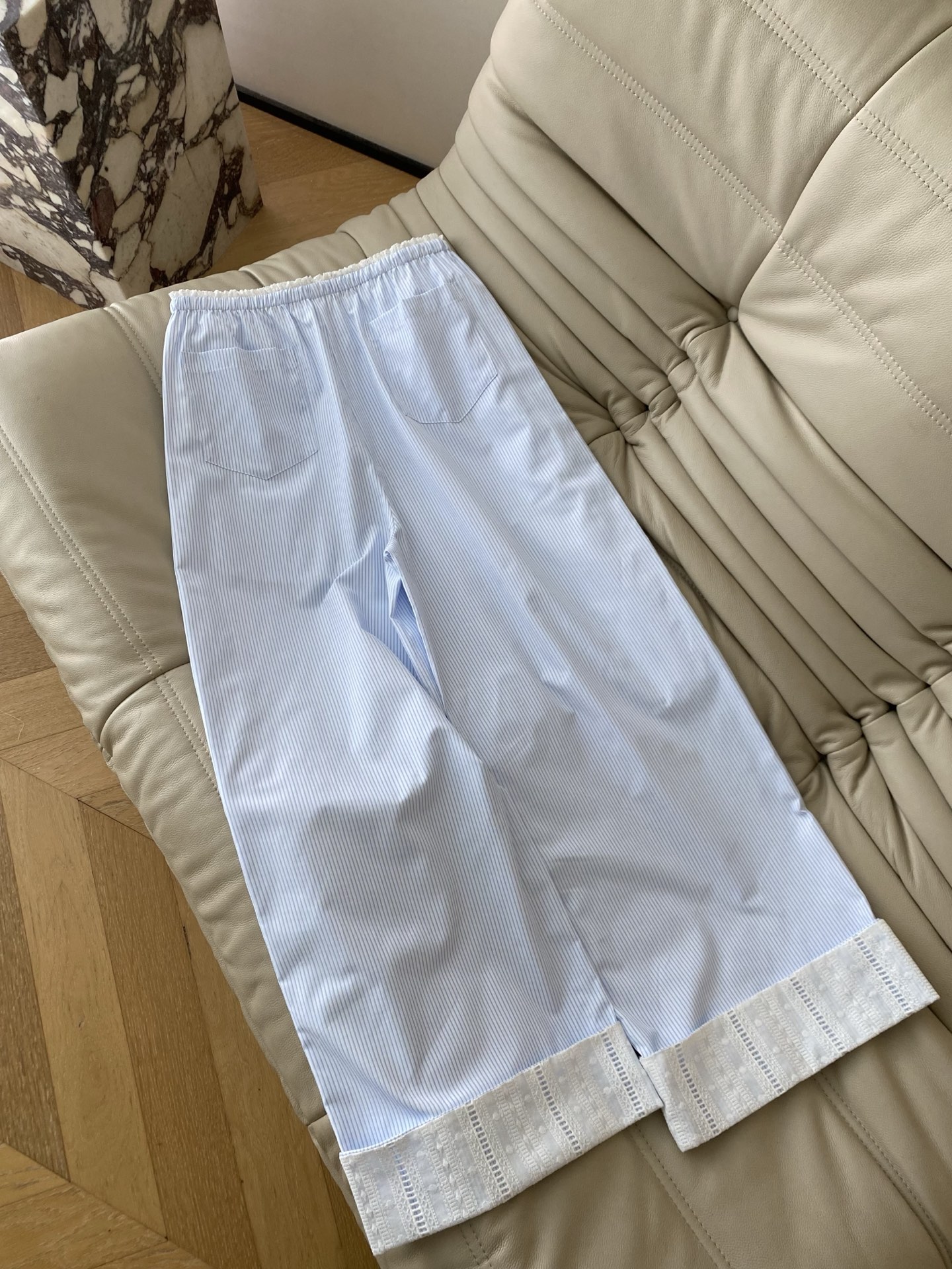 26SS 春夏新款浅蓝条纹蕾丝阔腿裤采用垂顺透气的棉感面料打造慵懒直筒版型，清爽浅蓝细条纹腰头抽绳+门襟