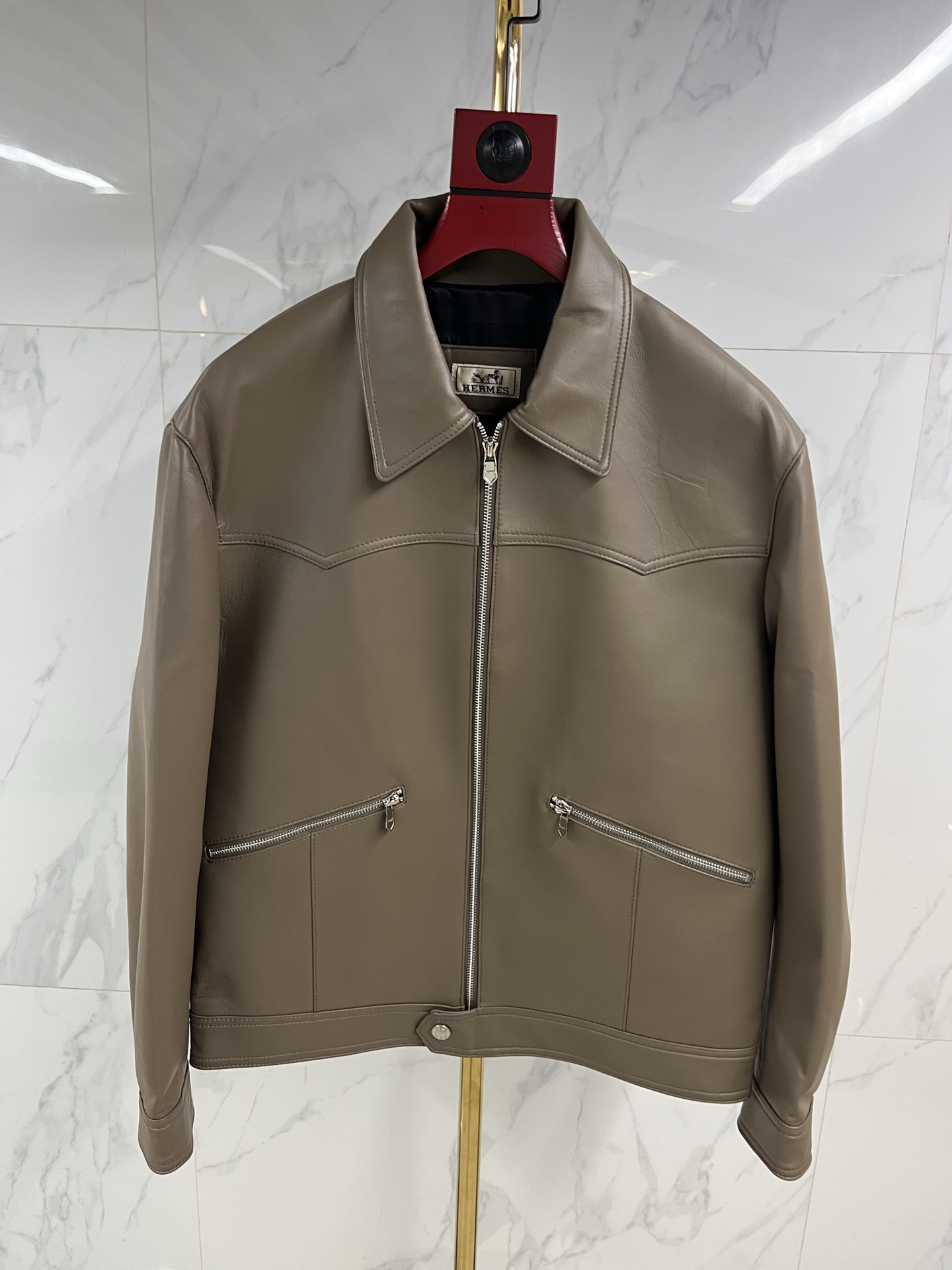 NO:822344,Hermes men's sheepskin lapel leather jacket  As warm and moist as ever, when the cold wind of the city comes, a Hermès sheepskin lapel leather jacket is the armor for you to be calm and leisurely. Select top-grade sheepskin, which feels as delicate and flexible as silk, surpassing ordinary sheepskin, light and fit the body, but rich in texture  It hides extraordinary muscles and bones. The natural leather surface flows over time, depositing a deep and warm unique luster, telling a story that only belongs to you. Every inch is dedicated to extraordinary skills by Hermès craftsmen. The sharp lapels outline the sharp outlines and are precisely cut.  The tailoring gives the shoulder line impeccable grace. The button opening and closing are meticulously detailed. The lining is lined with silky fabric, which continues the luxurious feel in a low-key manner. This is not only a barrier against the cold wind, but also a silent expression of the contemporary gentleman's character.  Declaration. From the sharpness and connotation of business meetings to the freedom and ease of traveling in the city, it always has a warm texture to accompany you in different scenes. Hermès leather jackets are carved with time and style, and one piece is eternal - the longer the time, the better they understand you.  Code number 48——58 Coding: ---,Hermes-clothing,hermes,leather jacket,sheepskin,19860909爱马仕男士绵羊皮翻领皮衣 温润如初,当城市寒流裹挟而至,一件爱马仕绵羊皮翻领皮衣,便是你从容不迫的铠甲.甄选顶级绵羊皮,触感如丝般细腻柔韧,超越普通羊皮,轻盈贴合身姿,却蕴藏不凡筋骨.天然皮面随时间流转,沉淀出深邃温润的独有光泽,诉说只属于你的故事.每一寸皆由爱马仕工匠倾注非凡技艺,利落翻领勾勒棱角分明的轮廓,精准剪裁赋予肩线无可挑剔的英挺.纽扣开合间,是严丝合缝的细节执着.内里衬以丝滑织物,于低调中延续奢华体感.这不仅是抵御寒风的屏障,更是当代绅士品格的无声宣言.从商务会晤的锋芒内蕴,到都市穿梭的洒脱自如,它始终以温润质感,伴你游刃于不同场景.爱马仕皮衣,以时光雕琢风度,一件即永恒——时间越久,越懂你. 码数48———58编码: ---,爱马仕-服装,hermes,leather jacket,sheepskin,,Women's clothing
