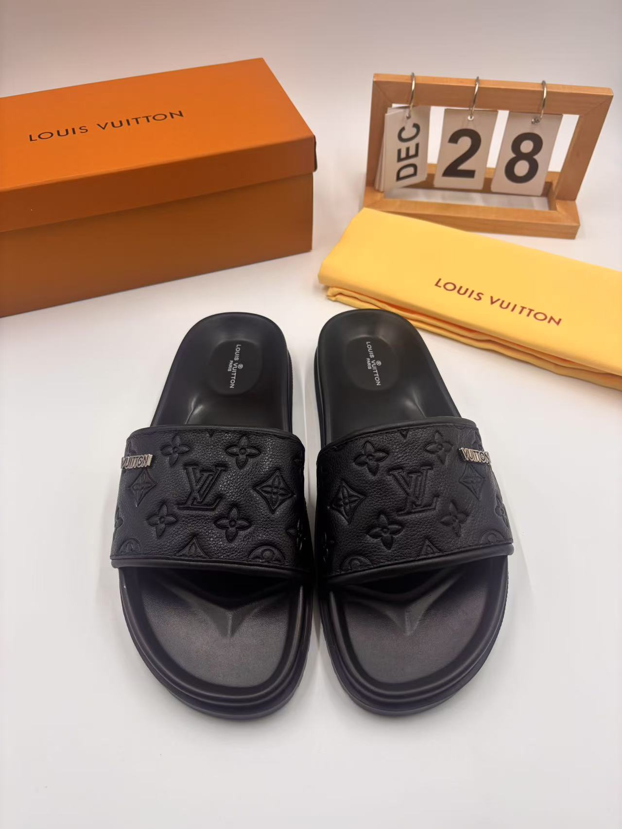 Elegant Louis Vuitton Men's Black Leather Monogram Embossed Slides