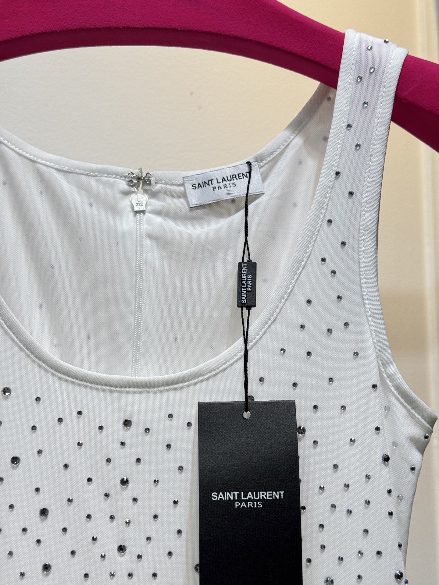 slp水钻连体衣通体装饰水钻，采用无袖、低圆领剪裁，背部配备拉链与底部按扣设计，兼具装饰性与穿脱便利性融