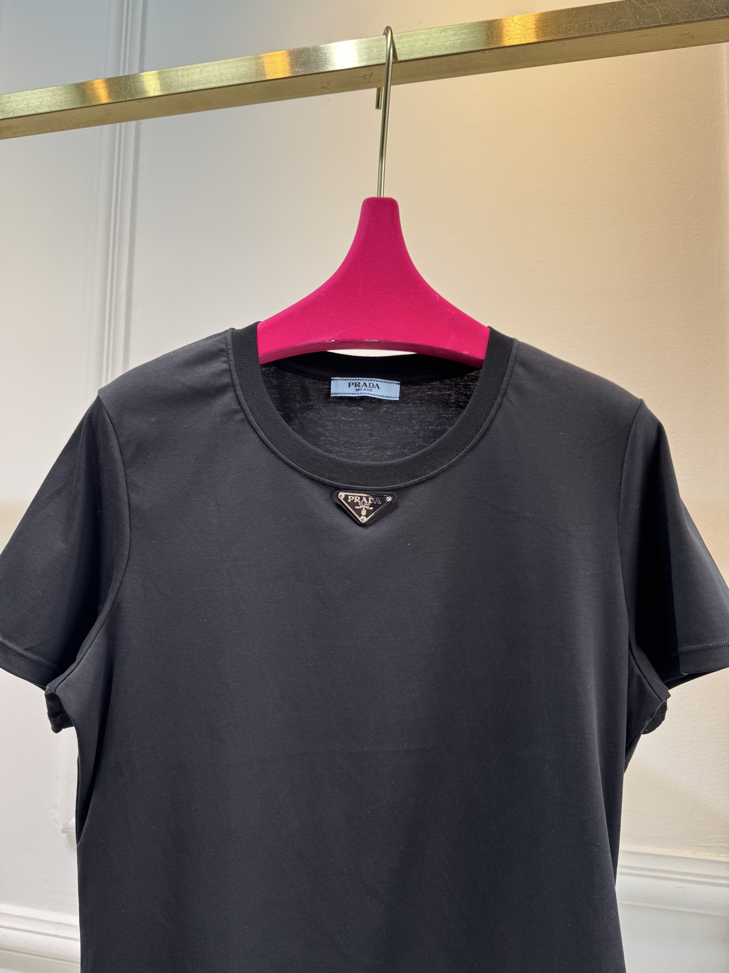 Prad*三角标圆领短袖T恤，胸前正下方的金属三角徽标是Prada的经典标识，采用品牌专属的金属材质与浮
