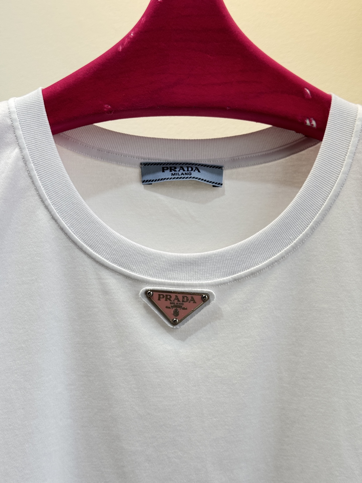 Prad*三角标圆领短袖T恤，胸前正下方的金属三角徽标是Prada的经典标识，采用品牌专属的金属材质与浮