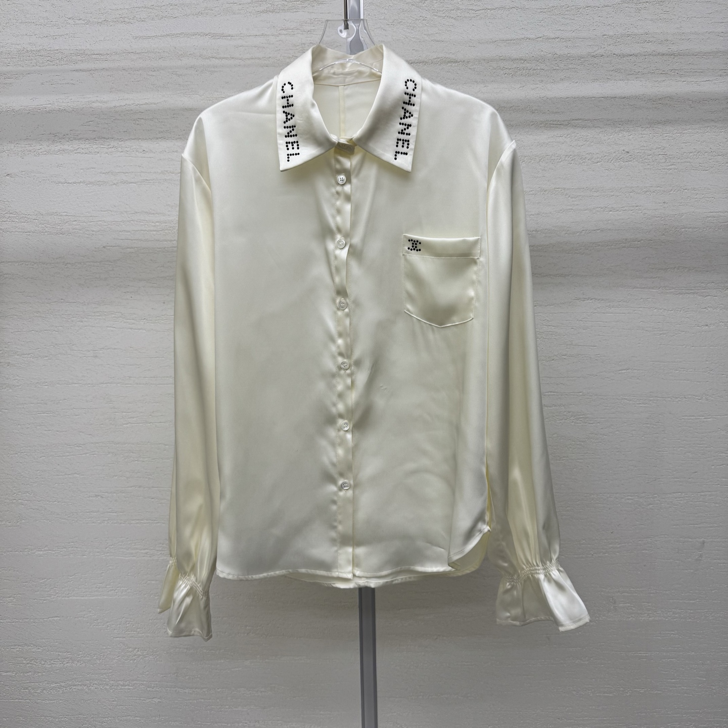 NO:753874,Support exchange Chane*26Ss early spring new style long-sleeved shirt with rhinestones on the lapel丨exclusively developed by yb!  High quality production!  Made of high-grade silk satin fabric as the base, the beige low-key texture has a warm vertical texture. The lapel letter logo is embellished with hot-drilling technology, which reflects the fine luster under different lights, allowing the sense of luxury to be integrated into daily life. The lantern sleeve design creates a relaxed and casual atmosphere, and can also easily enhance the sophistication of the overall look. It is a must-have item in the early spring wardrobe that has both style and practicality. Ready-made S/M/L real shot details, chanel, shirts, silk fabric,19860909支持换款Chane*26Ss早春新款 翻领字烫钻长袖衬衫丨独家yb开发！高版出品！以高级丝质绸缎面料为底,米色系低调肌理自带温暖垂直质感.翻领字母标识采用烫钻工艺点缀,在不同光线下折射出细碎光泽,让奢华感融入日常,灯笼袖设计打造松弛随性的氛围感,还都能轻松提升整体造型的精致度,是早春衣橱里兼具格调与实穿性的必备单品.现货发售S/M/L实拍细节图,,chanel,shirts,silk fabric,,Women's clothing