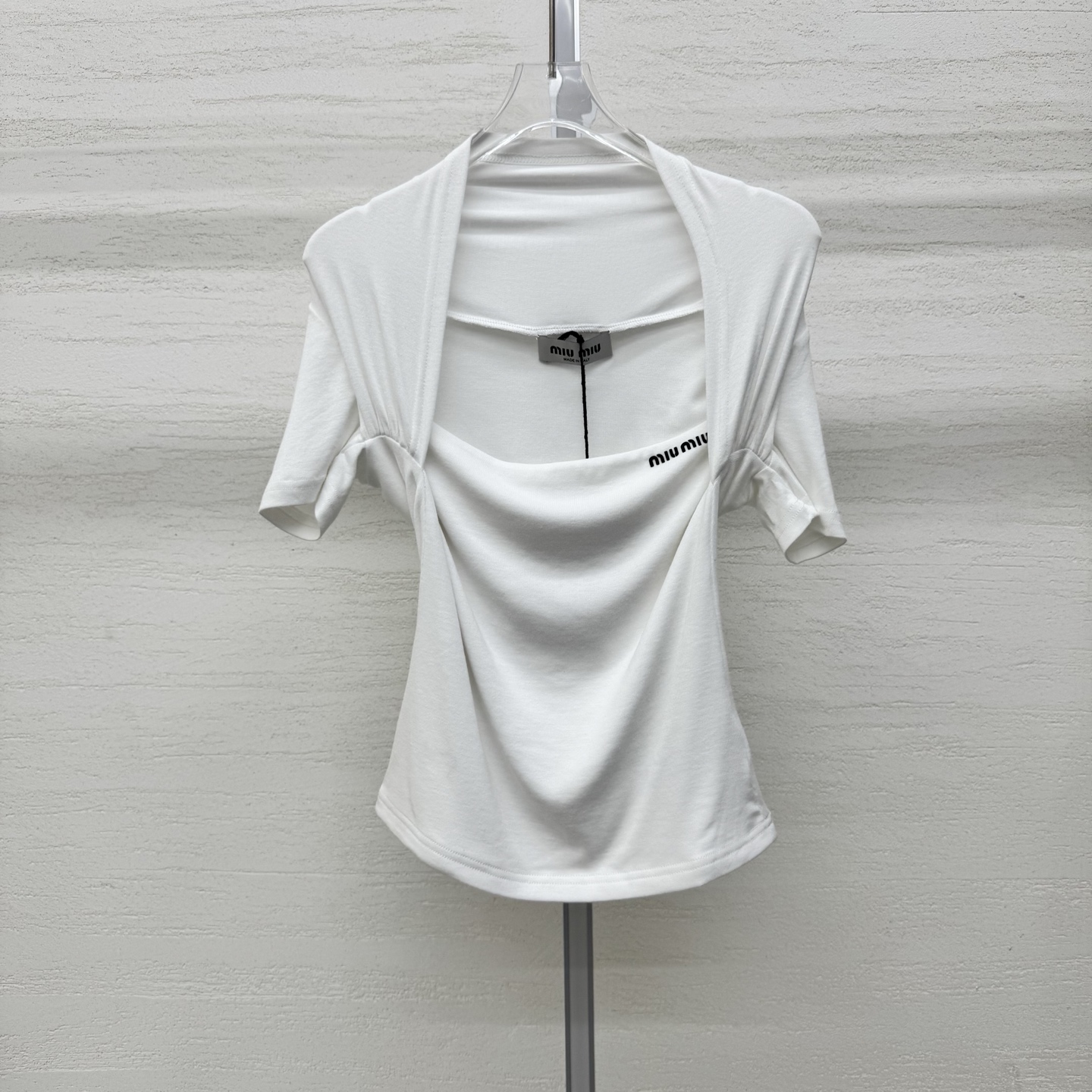 NO:759221,Support exchange Miumi* 26Ss early spring new style square collar halter neck slim skin-friendly short sleeves丨Exclusive high-end version!  We select skin-friendly, soft and waxy high-elastic fabrics that fit the body like the second layer of skin and outline graceful curves. The minimalist logo is embellished on the neckline, showing a luxurious texture in a low-key manner. Whether worn alone to create a bright focus, or layered with a suit or windbreaker as an inner layer, it can easily become the finishing touch of the look. Available now. Black and white S/M/L real shot details,, miumiu, T-shirt, business suit,19860909支持换款Miumi* 26Ss早春新款 方领挂脖修身亲肤短袖丨独家高版出品！甄选亲肤软糯的高弹面料,如第二层肌肤般贴合身形,勾勒出曼妙曲线.极简的logo点缀在领口,低调中尽显奢华质感,无论是单穿打造明艳焦点,还是叠穿西装、风衣作为内搭,都能轻松成为造型的点睛之笔.现货发售 黑白两色S/M/L实拍细节图,,miumiu,T-shirt,business suit,,Women's clothing