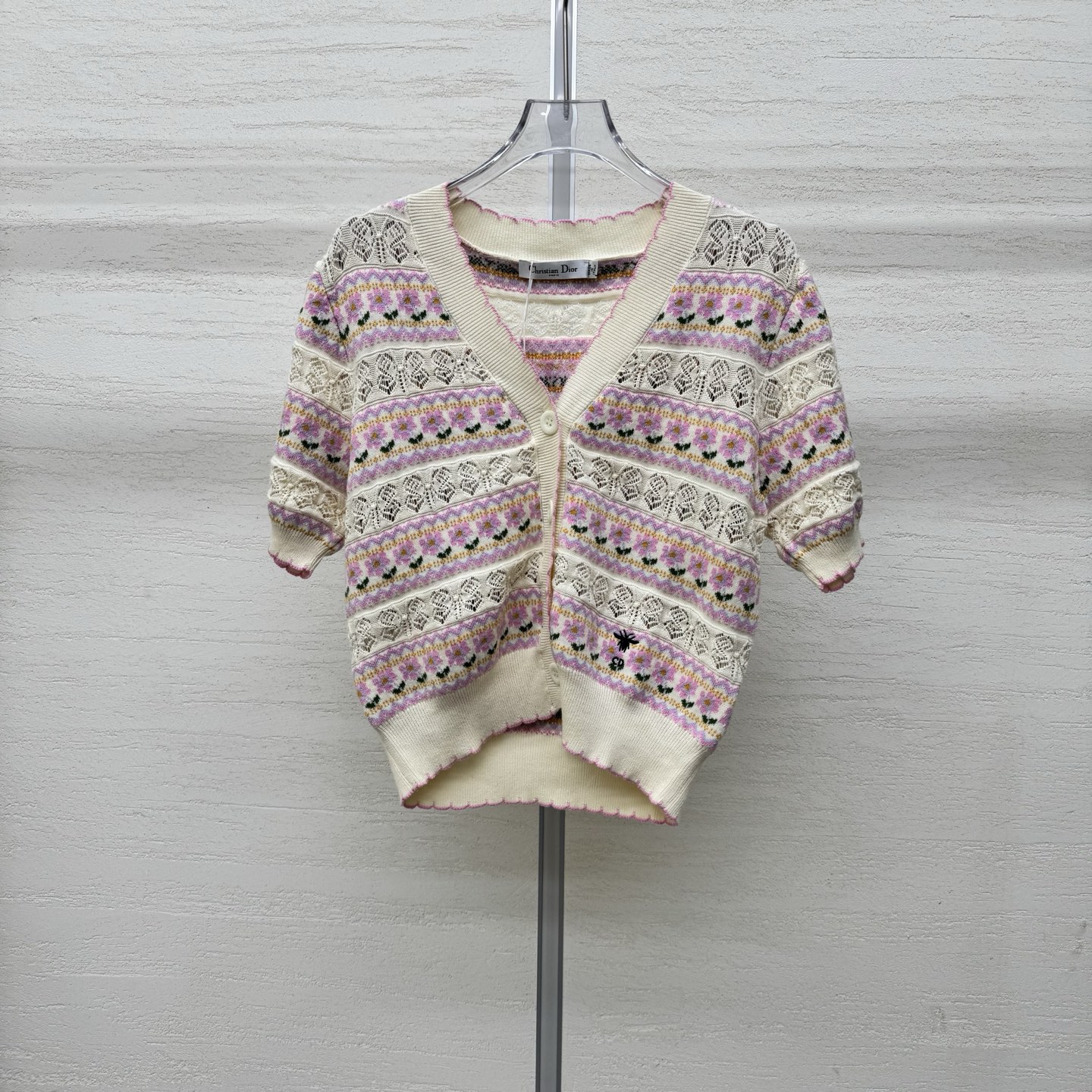 NO:760717,Supports the exchange of Dio*26ss new spring and summer short-sleeved knitted cardigan. It interprets spring style and outlines a dreamy atmosphere with soft tones. Off-white background color with pink and purple flower patterns. Exquisite and smart. Every pattern tells elegance. Unique hollow design adds layering and breathing. Iconic bee elements are low-key embellishments to highlight the brand style. V-neck and button design modify the neck line. Playful wavy edges show sweetness. Ready for sale. Size  363840 real shot details,,dior,T-shirt,19860909支持换款Dio*26ss春夏新款短袖针织开衫 演绎春日风情以柔和色调勾勒梦幻氛围 米白底色搭配粉紫花朵图案 精致且灵动 每一处花纹都诉说着优雅 独特镂空设计 增添层次感与呼吸感 标志性蜜蜂元素低调点缀 彰显品牌格调 V领与纽扣设计 修饰颈部线条 俏皮波浪边尽显甜美 现货发售 尺码 363840实拍细节图,,dior,T-shirt,,Women's clothing