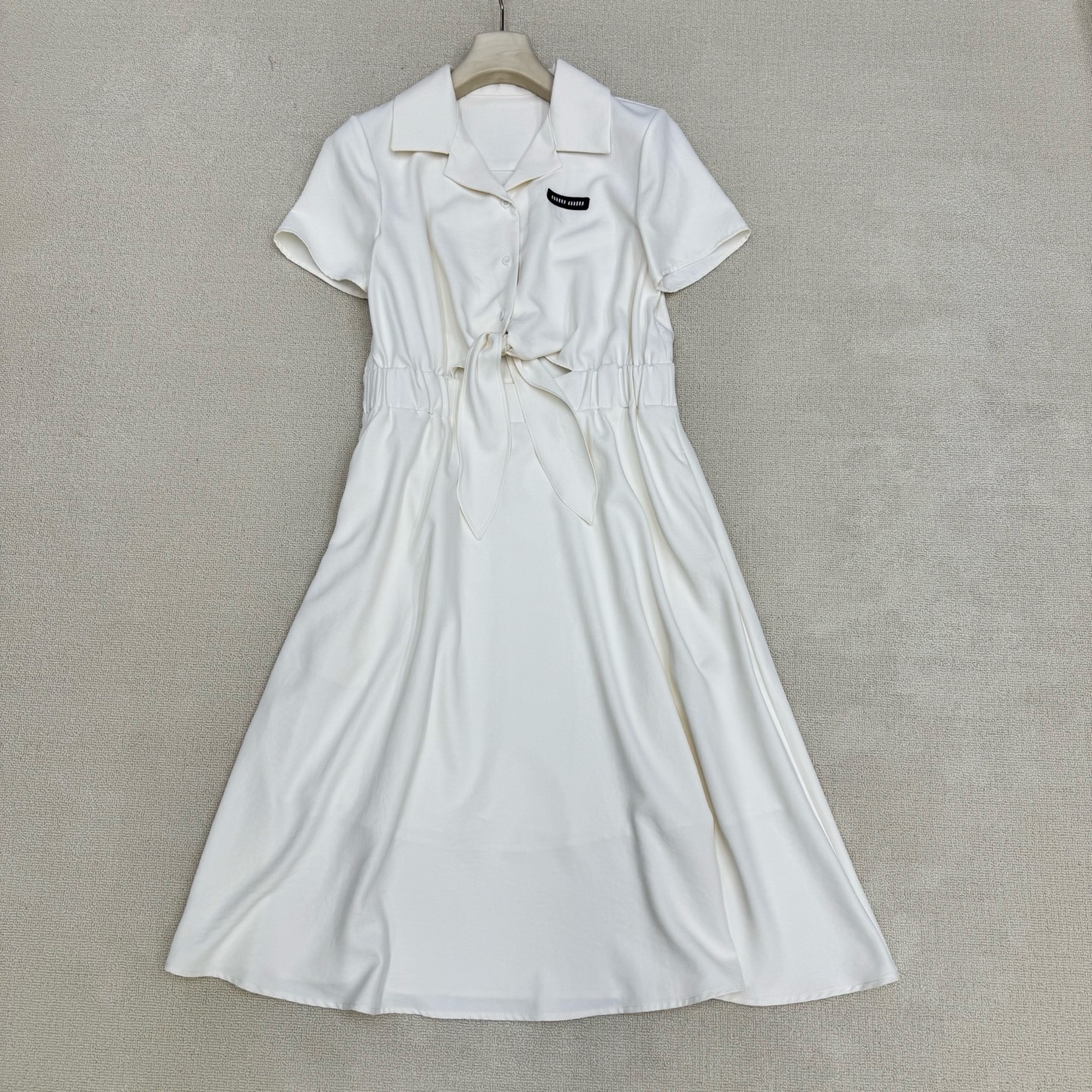 NO:844689,Miu* 26Ss new spring and summer shirt-style waist strap dress丨Exclusive high-end version!  Shirt-style small lapel design, modifying the swan neck and right-angled shoulders. The elastic waist + shoulder straps hide the flesh and show off the temperament. The upper body automatically shapes the body curve. The three-dimensional micro logo on the chest is the iconic element of the Miu series. The ribbon has a perfect drape, which is sweet but not greasy. The high waistline + umbrella-shaped skirt optimizes the body proportions in one second and brings a sense of atmosphere when walking; off-white/navy blue  Available in two colors, you can wear it on dates, commuting, or vacations ~ ready for sale in S/M/L, miumiu, skirts, shirts,19860909Miu* 26Ss春夏新款 衬衫式腰间挷带连衣裙丨独家高版出品！衬衫式小翻领设计,修饰天鹅颈与直角肩,松紧腰+挷带既藏肉又显气质 上身自动塑造身材曲线 胸前立体微标 是Miu系标志性元素,飘带垂坠感满分,甜而不腻；高腰线+伞型裙摆,一秒优化身材比例,走路自带氛围感；米白/藏蓝 双色可选,约会/通勤/度假都能穿～现货发售S/M/L,,miumiu,skirts,shirts,,Women's clothing