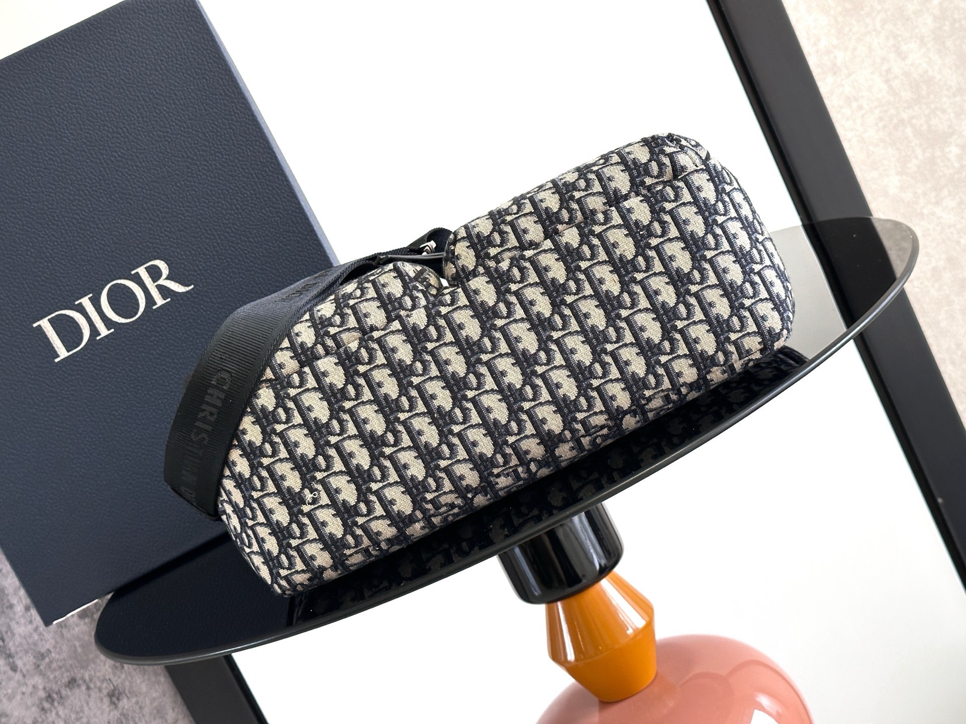 这款 Rider Soft 水饺包是二零二五秋季男装系列新品,兼具实用功能与时尚设计。采用米色和黑色 O