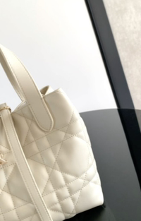 Este bolso vertical Dior Toujours es elegante, práctico y único. Confeccionado en cuero de vaca negro y decorado con pe…
