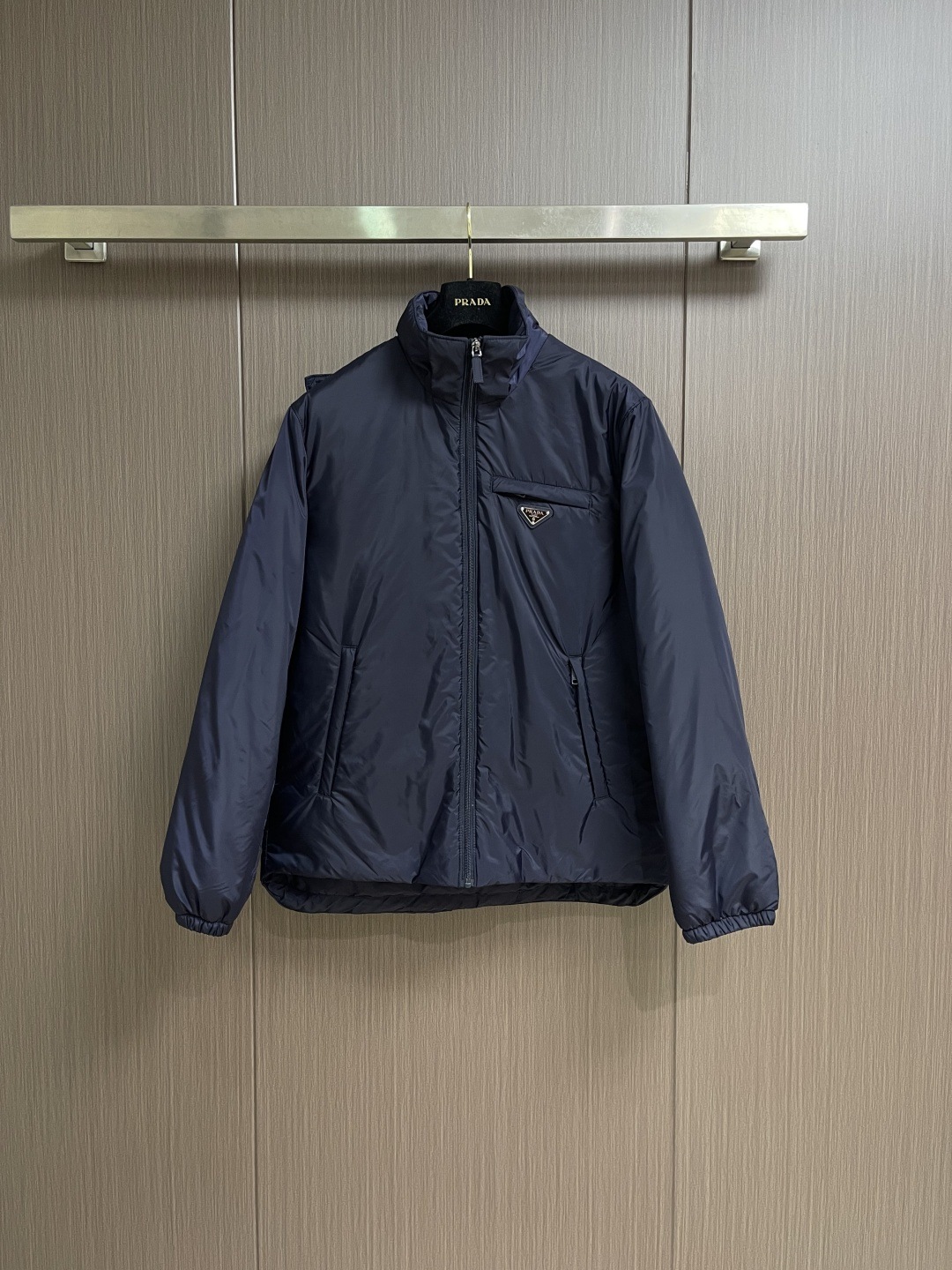 PRADA 2025FW秋冬新款连帽羽绒外套，选用品牌标志性的再生尼龙面料，与传统尼龙性能相当，具备高强