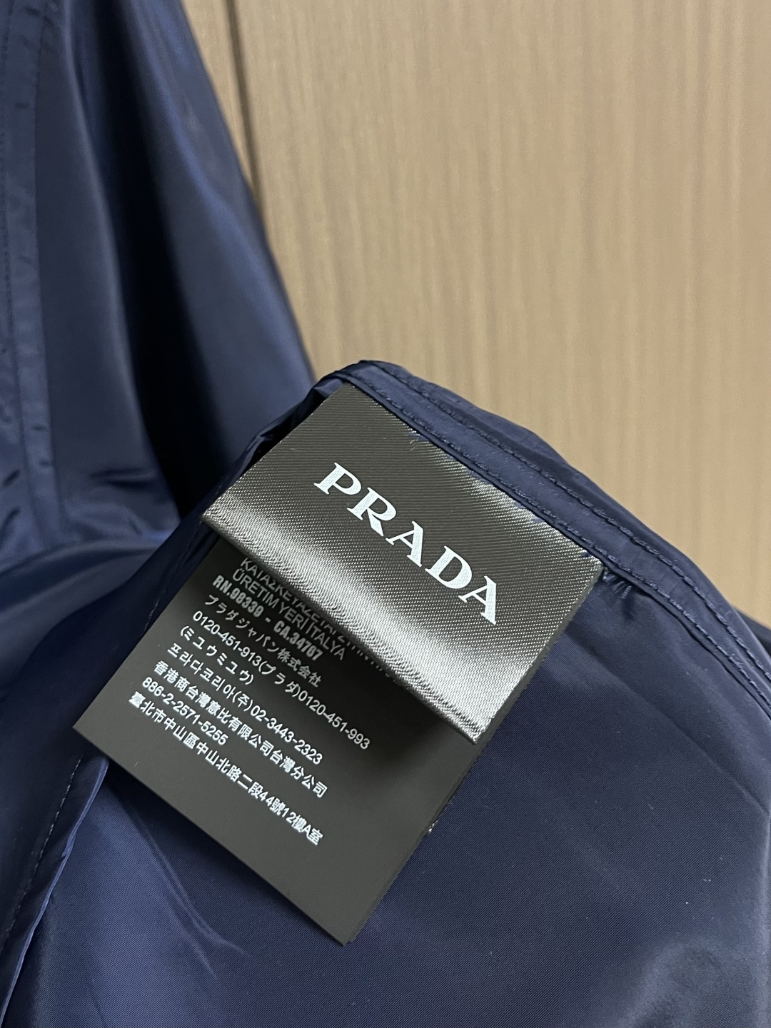 Prada 再生尼龙衬衫，Re-Nylon赋予这款经典剪裁衬衫技术风格，混搭设计融合裁缝优雅与功能性。圆