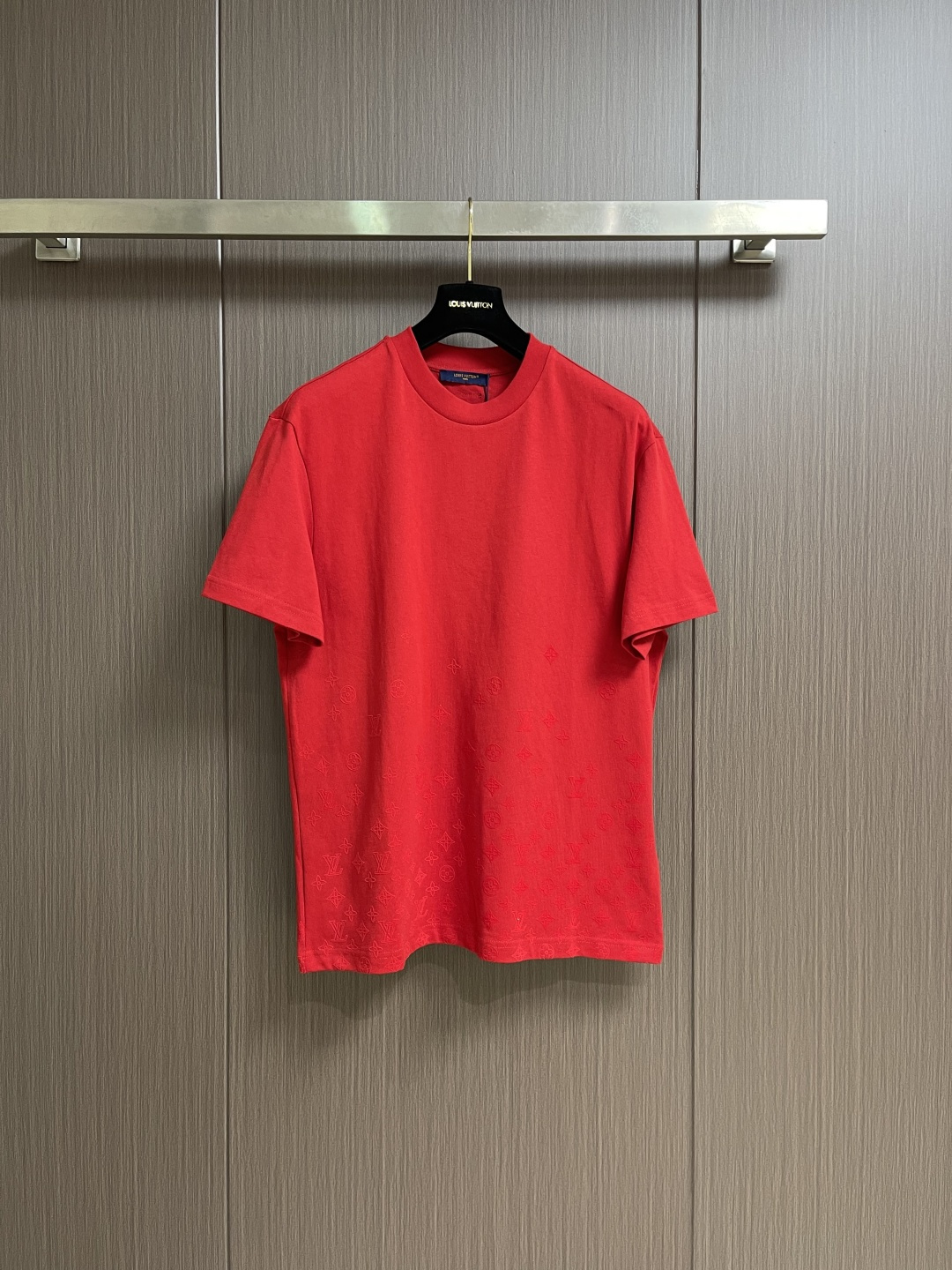 NO:775953,LV  Velvet printed round neck short-sleeved T-shirt, the neckline adopts high-density tight rib. The double yarn structure makes the rib tissue denser and has excellent elastic recovery rate, which can effectively prevent the neckline from loosening and deforming after repeated wearing and taking off. The double yarn rib has a higher thickness and stiffness, forming a harmonious unity with the thick needle body. Printed with environmentally friendly elastic glue +  The thick plate flocking process is combined, and the pattern is treated with the same tone process. It spreads quietly from the hem, and the pattern design requires precise control of the starting position and gradient rhythm of the printing. A dense pattern begins to appear from the hem, and gradually becomes sporadic embellishments upward until it disappears. This layout makes the visual center of gravity sink, which is in harmony with the stability of the classic silhouette.  Form a response. Environmentally friendly elastic glue is used as the base or adhesive. The glue has excellent elasticity and adhesion, can extend simultaneously with the stretching of the fabric, and is not easy to crack and fall off. The thick plate flocking process uses electrostatic flocking technology to implant short fiber fluff into the undried glue pattern area to form a three-dimensional fluff layer. After flocking, it is subjected to high temperature  It is baked and fixed to make the fluff adhere firmly. Thick plate flocking is characterized by full suede, soft touch, and visually matte soft texture. Combined with the same-tone processing, the brand logo spreads quietly from the hem, forming a low-key and elegant gradient effect. The overall wiring is straight and delicate, the fabric is comfortable and soft, and the color is consistent without color difference.  It can be matched with the same style to create a fashionable look, and can be used in various occasions. Customized accessories, complete with three standards, same style for men and women!  Size XS-L19860909LV 绒毛印花圆领短袖T恤,领口采用高密度紧实罗纹.双纱结构使罗纹组织更加致密,弹性恢复率优异,能有效防止领口在反复穿脱后松垮变形.双纱罗纹的厚度与挺括度更高,与粗针大身形成质感上的和谐统一采用环保弹力胶浆印花＋厚板植绒工艺相结合,图案采用同色调工艺处理.自下摆悄然铺展弥漫,版型设计需精准控制印花的起始位置与渐变节奏,从距下摆处开始出现密集图案,向上渐变为零星点缀直至消失.这种布局使视觉重心下沉,与经典廓形的稳定感形成呼应.以环保弹力胶浆作为底浆或粘合剂,该胶浆具有优异的弹性与附着力,能随面料拉伸而同步延展,不易开裂脱落.厚板植绒工艺通过静电植绒技术,将短纤维绒毛植入未干固的胶浆图案区域,形成立体绒毛层.植绒后经高温烘烤固定,使绒毛牢固附着.厚板植绒的特点是绒面饱满、触感柔软、视觉呈哑光柔和肌理,与同色调工艺处理相结合,使品牌标识自下摆悄然铺展弥漫,形成低调而雅致的渐变效果.整体走线平直细腻,面料舒适柔软,颜色一致无色差 能与同款搭配营造时尚造型,驾驭各种场合,定制辅料,三标齐全,男女同款！尺码XS-L XS码胸围106肩宽49.5衣长69 S码 胸围110 肩宽51衣长71 M码胸围114 肩宽52.5衣长73 L码 胸围118 肩宽54.5衣长75,,louis vuitton,T-shirt,tees，t-shirt,,Men's clothing