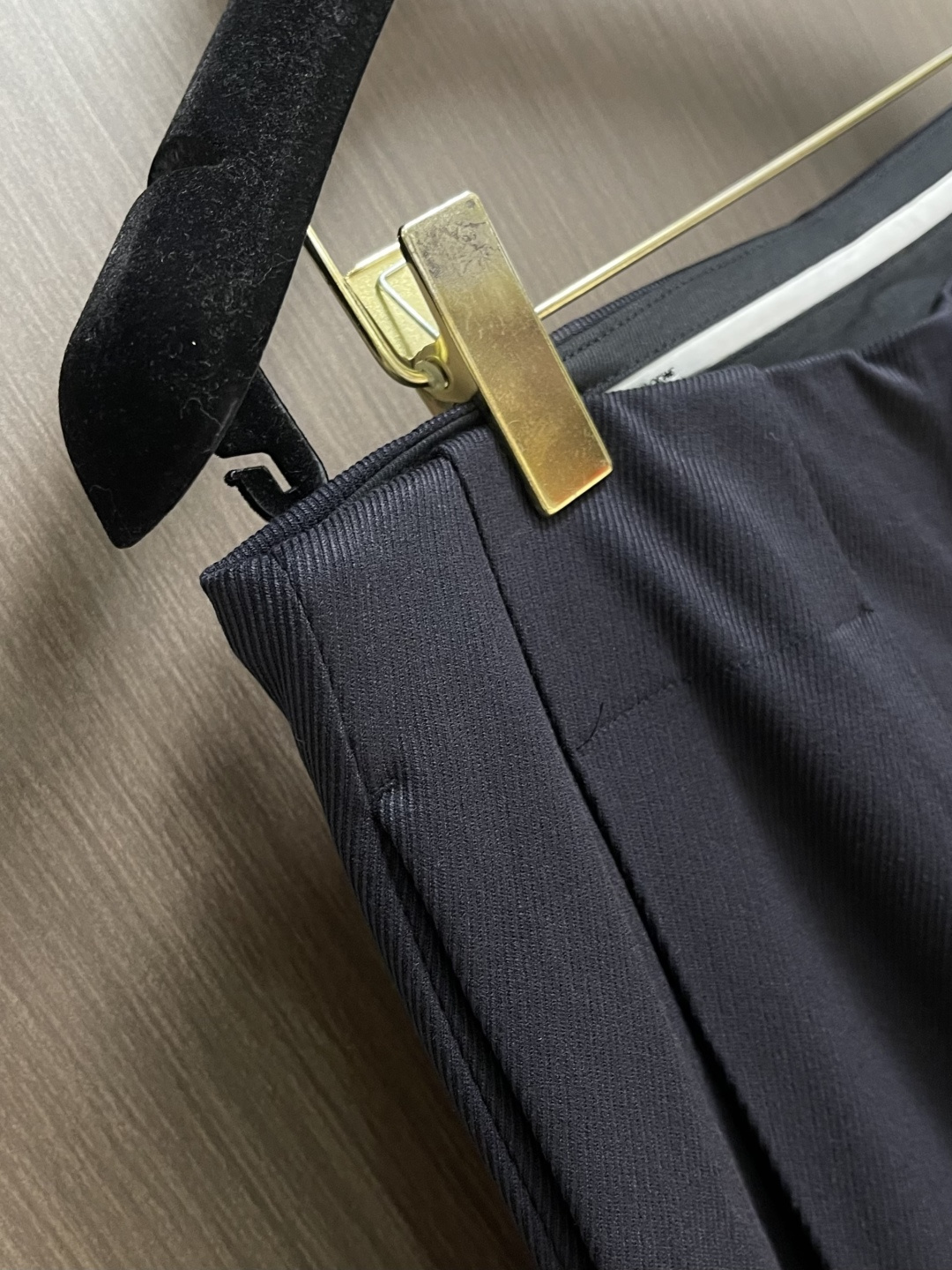 Loewe 皮牌休闲裤，定制丝光雾面羊毛，以雾感深海军蓝为主色调，腰头正面饰有LOE 压纹皮革贴片，与纽