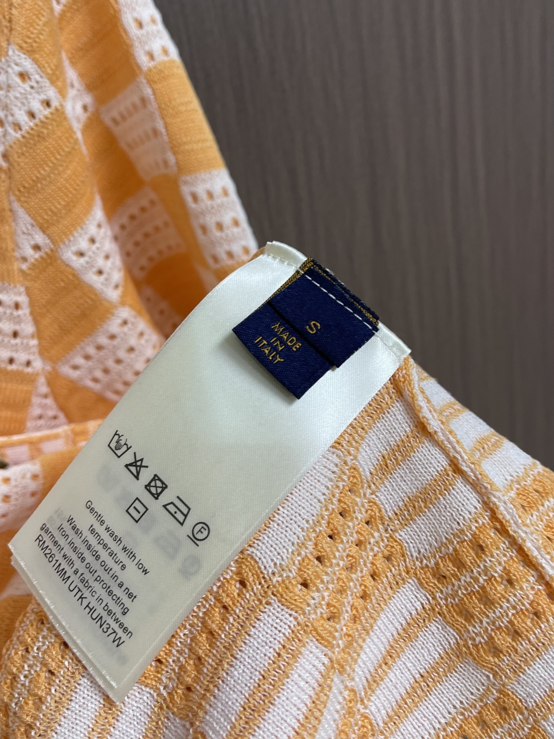 LV 橙白棋盘格肌理针织开衫，采用镂空针织工艺打造橙白棋盘格肌理，经典领搭配撞色罗纹包边，领部与袖口以白