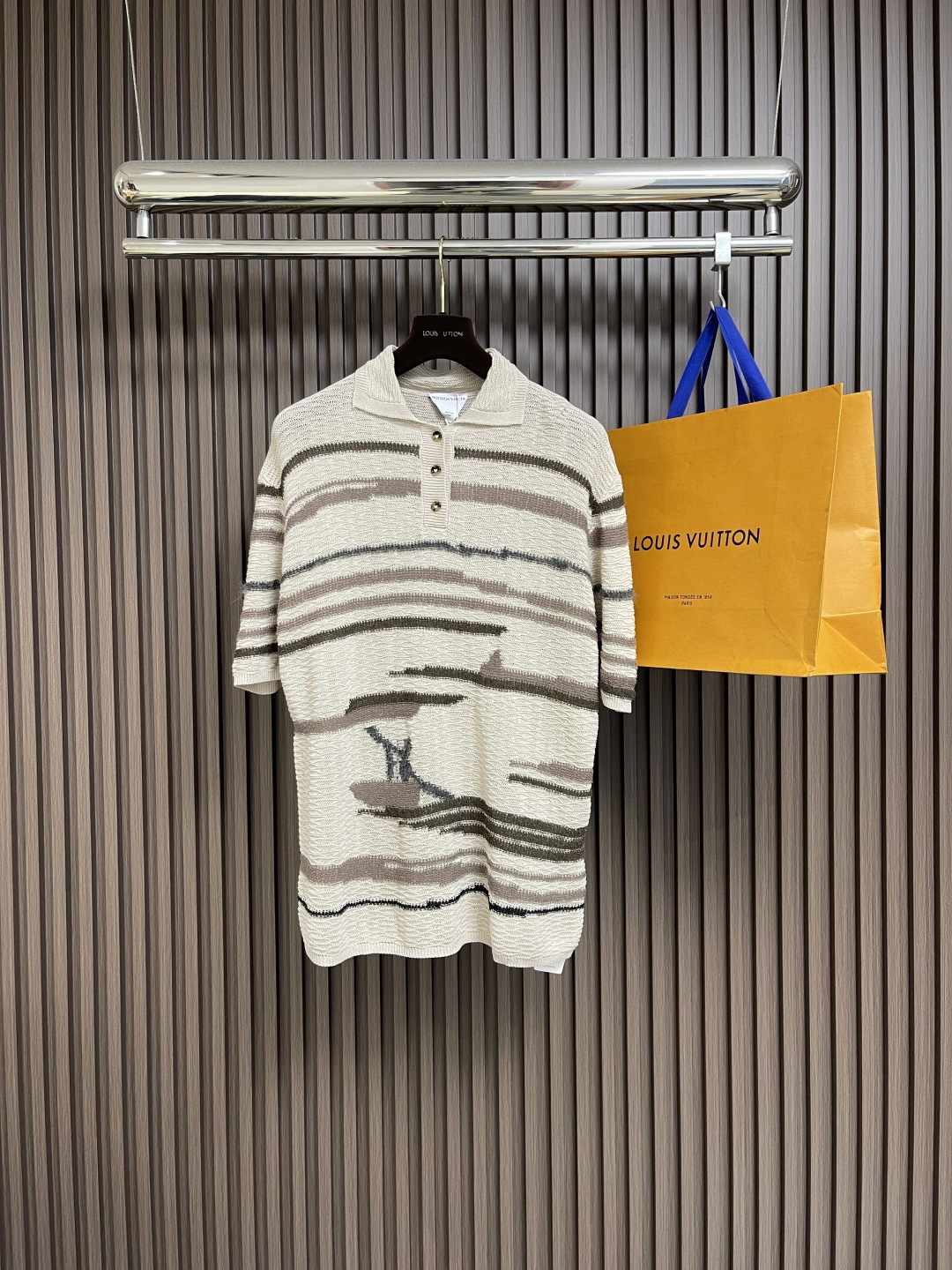 NO:493031,BV Bottega Veneta ink elements knitted short-sleeved POLO shirt, Bottega Veneta  The spring and summer series is inspired by the iconic gondola boat in Venice. This Polo shirt uses exquisite inlay craftsmanship, cleverly woven high-quality linen and cotton fabrics to create a unique texture effect. The fabric has been specially treated, which not only retains the natural texture of linen, but also enhances the comfort of cotton. The stripes in the earth-colored color are calm and elegant, and the smooth line feel echoes the artistic conception of gondola paddles passing through the water. The body is neat, the shoulder line is designed in detail, and the hem is cut by a classic Polo shirt. The fabric has good breathability and is suitable for wearing in spring and summer. In terms of craftsmanship details, the neckline and cuffs are reinforced by dense pins to ensure durability. The buttons are made of natural materials, harmoniously unified with the overall tone. This Polo shirt shows Bottega  Veneta's consistent exquisite craftsmanship and Italian aesthetics are suitable for daily leisure or business leisure occasions, perfectly interpreting the brand's low-key and luxurious design concept. Size S-M-L, bottega veneta, bottega veneta, T-shirt, alexander wang19860909BV Bottega Veneta水墨元素针织短袖POLO衫,Bottega Veneta 春夏系列灵感源自威尼斯标志性的贡多拉船.这款Polo衫采用精湛的嵌花工艺,将优质亚麻与棉质面料巧妙编织,创造出独特的纹理效果.面料经过特殊处理,既保留了亚麻的天然质感,又提升了棉质的舒适度.大地色系的条纹设计沉稳优雅,流畅的线条感呼应了贡多拉船桨划过水面的意境.衣身廓形利落,肩线设计考究,下摆采用经典Polo衫剪裁.面料具有良好透气性,适合春夏季节穿着.工艺细节方面,领口与袖口采用密实针脚加固,确保耐用性.纽扣选用天然材质,与整体色调和谐统一.这款Polo衫展现了Bottega Veneta一贯的精湛工艺与意式美学,适合日常休闲或商务休闲场合,完美诠释品牌低调奢华的设计理念.尺码S-M-L,,bottega veneta,bottega veneta,T-shirt,alexander wang,Men's clothing