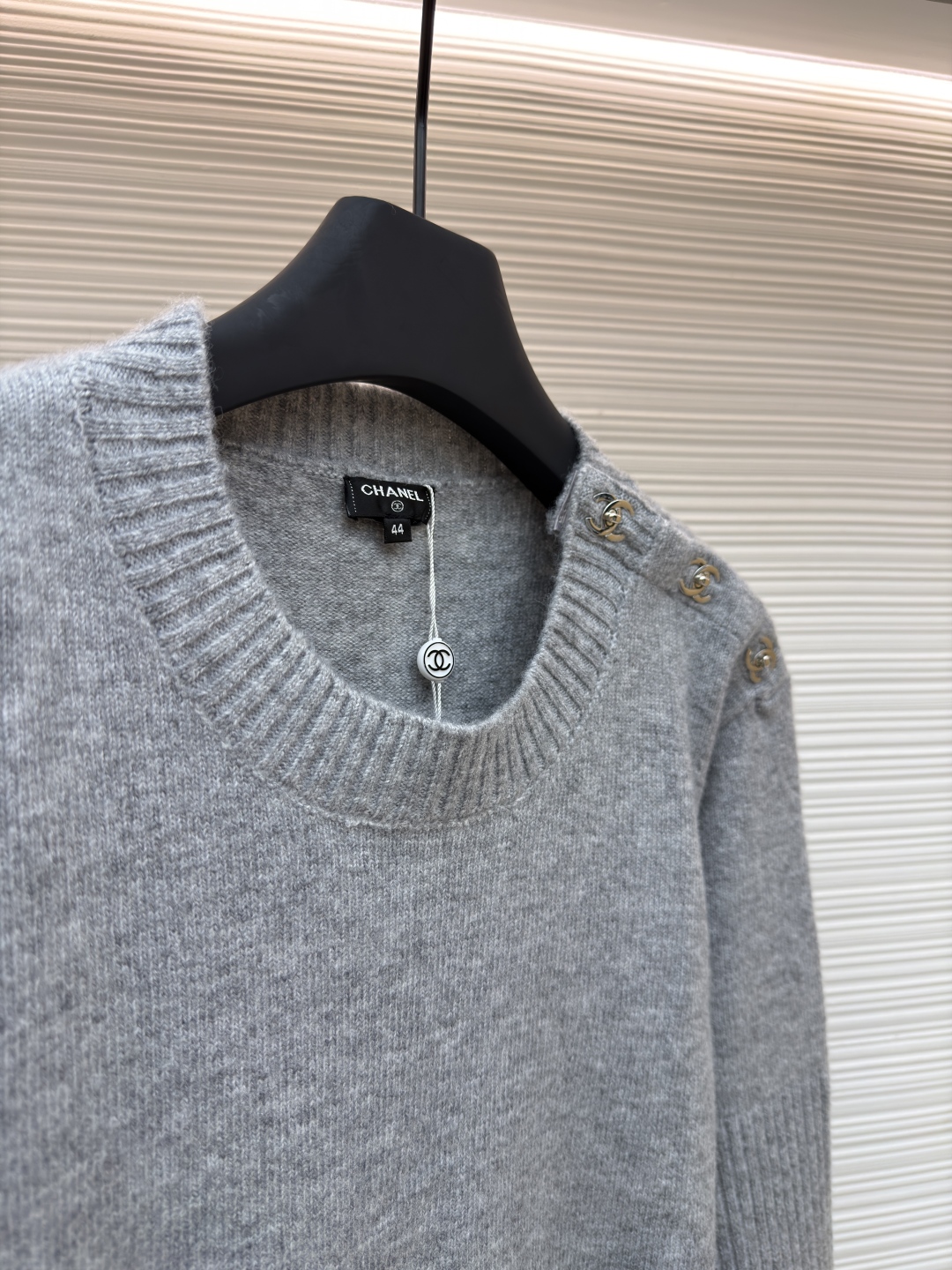 P230 Chanel 书包扣长袖毛衣
●货号：1680975-B00
●面料：百花绒镶羊毛面料
●工艺：成衣洗水制作
●版型：合身版型
●克重：约520克
●尺码：38-40-42-44-46
●描述定织百花绒镶羊毛织料 光泽自然 柔软亲肤 以深邃黑色为底色 不喧哗却自带光芒 肩部巧妙融入标志性香奈儿书包扣设计 宛如灵动的音符 为简约轮廓注入奢华灵魂 以慵懒而不失优雅的姿态 贴合身体线条 在黑色的渲染下更显沉稳内敛 自成一道优雅风景，采用接缝立体缝线 它通过在接缝处使用特定的缝纫方法 使衣物呈现出更加立体和贴合身体的效果 做工繁琐复杂，人工专机起针打钉 在钉扣起始点 精确起针 采用高质量的针线和专用缝纫机 沿预设路径 匀速缝纫 保持力度均匀 确保缝线美观，成衣洗水加软去味工艺 通过专业的洗涤设备和特定的洗涤剂 对衣物进行深度清洁和去味处理 改善衣物的手感和外观。整体走线平直细腻，面料舒适柔软，颜色一致无色差 能与同款搭配营造时尚造型，驾驭各种场合，定制辅料，三标齐全，男女同款！