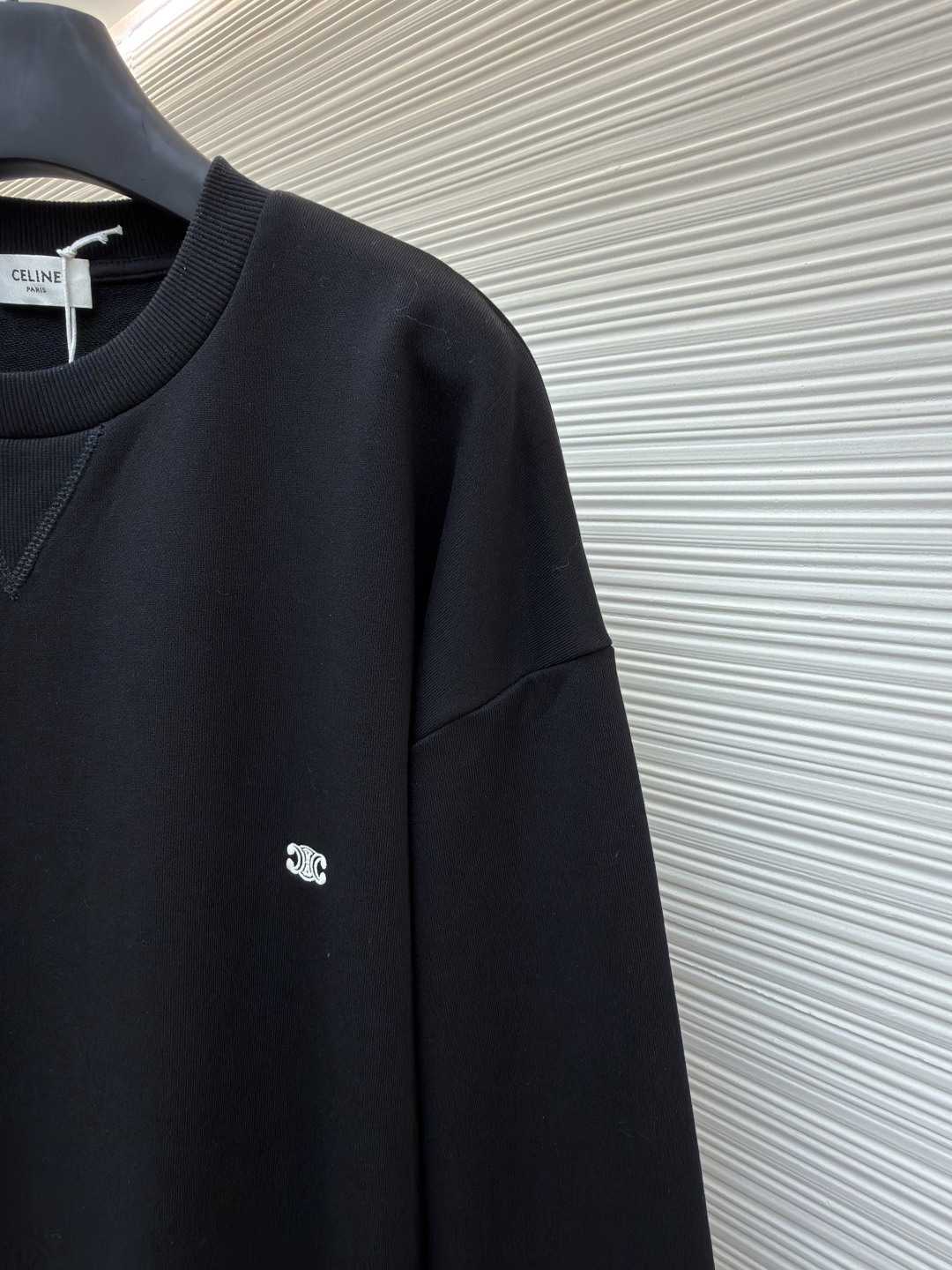 P165 Celine  凯旋门刺绣卫衣
●原版：8300购入开发
●货号：1682044-A35
●面料：全棉臻柔活性墨韵卫衣面料
●工艺：刺绣制作
●颜色：黑色
●版型：合身版型
●克重：约545克
●尺码：S-M-L-XL
●描述：定制全棉臻柔活性墨韵卫衣料 手感柔软 舒适亲肤 以一抹深邃黑幕为底 胸前悄然绘就一方三角形天地 标志性Celine 凯旋门标识点缀正面 以极致的简约勾勒出高级的轮廓  成为视觉的灵动焦点  于无声处彰显品味。采用进口机刺绣工艺 使用先进的计算机控制系统和精密的机械部件 实现凯旋门刺绣作业  精度高 线条流畅而细腻，面料都经过浇洗 手感质感更佳 不易变形 不易缩水 不易褪色 保持长久的美观。整体走线平直细腻，面料舒适柔软，颜色一致无色差 能与同款搭配营造时尚造型，驾驭各种场合，定制辅料，三标齐全，男女同款！