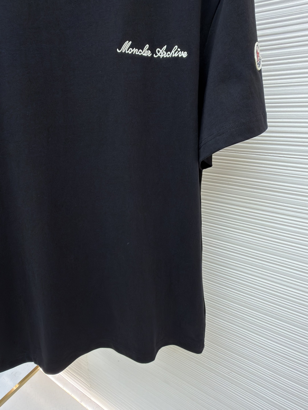 p220 Moncler 刺绣标识假俩件短袖
●原版：3500购入开发
●面料：云柔平纹棉面料
●工艺：刺绣制作
●颜色：黑色
●版型：合身版型
●克重：约320克
●尺码：S-M-L-XL
●描述：定制云柔平纹棉 柔软细腻 舒适贴肤 以极致黑为底 撞色为诗 让色彩拥有呼吸的层次 胸前饰以品牌字样刺绣标识作点缀 与手袖Moncler绣标相得益彰增添品牌辨识度 撞色双领口设计作升华 假两件的错觉美学 让高级感在似与不似之间生出无限想象 领间重构 风格自成采用进口机刺绣工艺 使用先进的计算机控制系统和精密的机械部件 实现Moncler标识刺绣作业  精度高 线条流畅而细腻。画样缝纫机工艺  通过电脑软件输入所需的图案 高精度的定位系统 确保图案在布料上的准确位置 具备自动缝纫功能 能够自动完成缝纫过程，面料都经过浇洗 手感质感更佳 不易变形 不易缩水 不易褪色 保持长久的美观。整体走线平直细腻，面料舒适柔软，颜色一致无色差 能与同款搭配营造时尚造型，驾驭各种场合，定制辅料，三标齐全，男女同款！