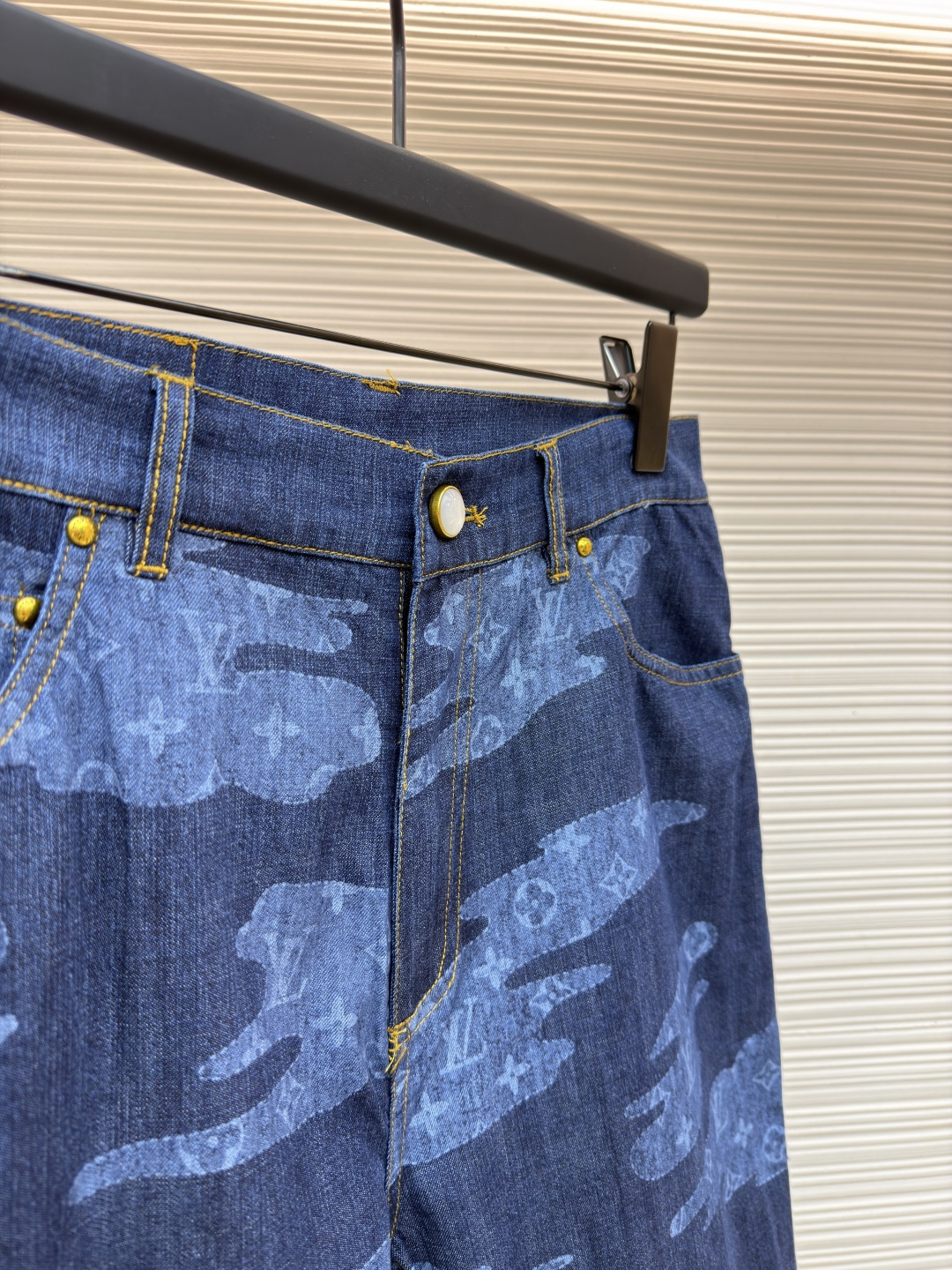 p355 LOUIS VUITTON 青年布短裤
●原版：12000购入开发
●面料：莱赛尔纤维牛仔布面料
●工艺：定位裁床制作
●颜色：蓝色
●版型：合身版型
●克重：约265克
●尺码：S-M-L-XL
●描述：这款路易威登青年布短裤采用重磅青年布面料，经成衣洗褪工艺处理，形成自然的做旧纹理与柔软触感，色牢度达4级以上，久洗不易褪色变形；面料兼具牛仔的挺括感与棉布的透气性，适合夏季穿着。短裤采用定位裁床工艺，精准对齐迷彩图案纹理，确保左右裤身花纹对称协调；腰头搭配定制工字扣与隐形袢带，提升穿着稳固性；侧缝与裆部采用双线加固缝制，针脚细密均匀，增强耐穿性；裤脚做自然毛边处理，保留复古质感。成衣经过整烫定型、线头修剪等多道后整理工序，版型宽松有度，适配日常休闲、户外出行等场景，兼具品牌辨识度与实穿性。整体走线平直细腻，面料舒适柔软，颜色一致无色差 能与同款搭配营造时尚造型，驾驭各种场合，定制辅料，三标齐全，男女同款！