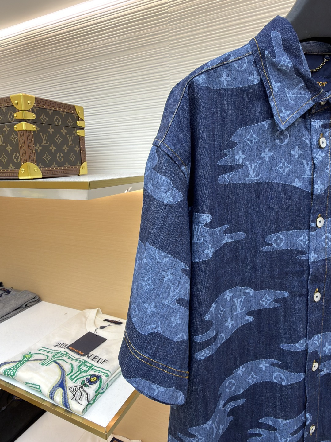 p365 LOUIS VUITTON  短袖青年布衬衫
●原版：13900购入开发
●面料：莱赛尔纤维牛仔布面料
●工艺：定位裁床制作
●颜色：蓝色
●版型：合身版型
●克重：约385克
●尺码：S-M-L-XL
●描述：这款路易威登短袖青年布衬衫采用重磅青年布面料，经成衣洗褪工艺处理，形成自然做旧纹理与柔软触感，色牢度达4级以上，久洗不易褪色变形，面料兼具牛仔挺括感与棉布透气性，适配多季节穿着。衬衫采用定位裁床工艺，精准对齐迷彩老花图案，确保左右衣身花纹对称协调；领部采用加固包边工艺，搭配定制天然贝壳扣，提升穿着稳固性与质感；侧缝与肩线采用双线缝制，针脚细密均匀，增强耐穿性；袖口做平缝锁边处理，保留利落版型。成衣经过整烫定型、线头修剪等多道后整理工序，版型宽松有度，适配日常通勤、休闲出游等场景，兼具品牌辨识度与实穿性。整体走线平直细腻，面料舒适柔软，颜色一致无色差 能与同款搭配营造时尚造型，驾驭各种场合，定制辅料，三标齐全，男女同款！