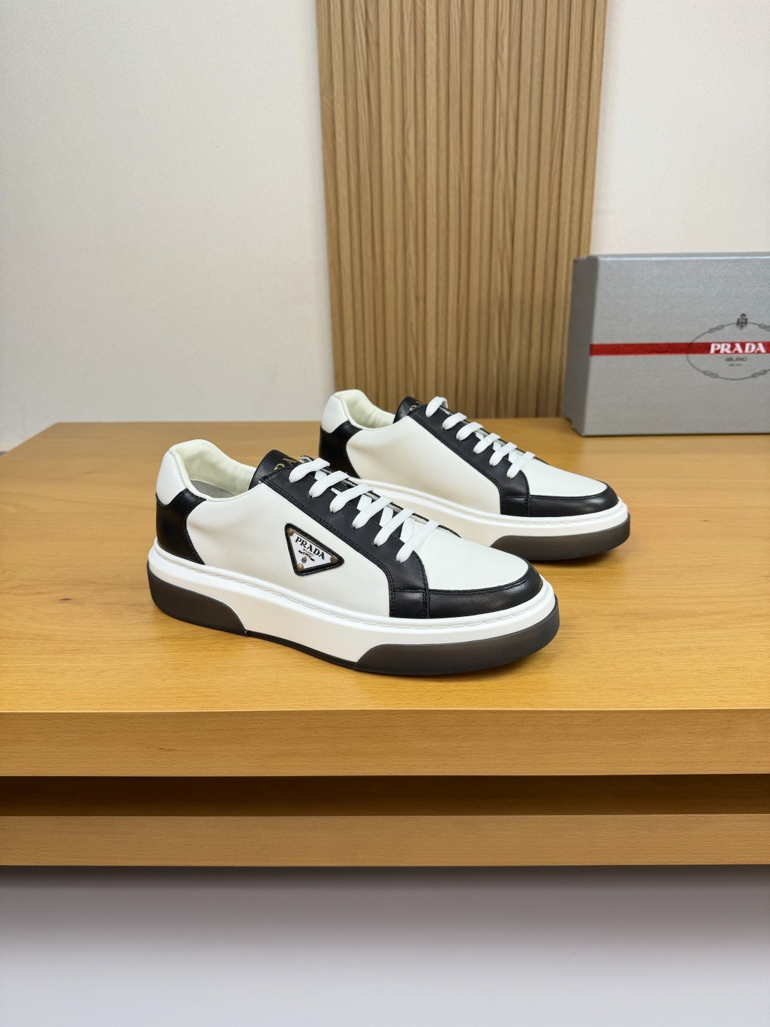 Prada Leather Sneakers with Metal Logo Detail - Casual Comfort & Style