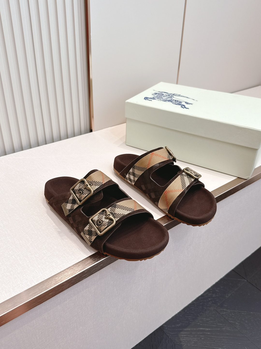 巴宝莉Burberry 经典拖鞋 选用柔软反绒面革面料打造，于意大利工坊精制而成。融入格纹图案压花，搭配
