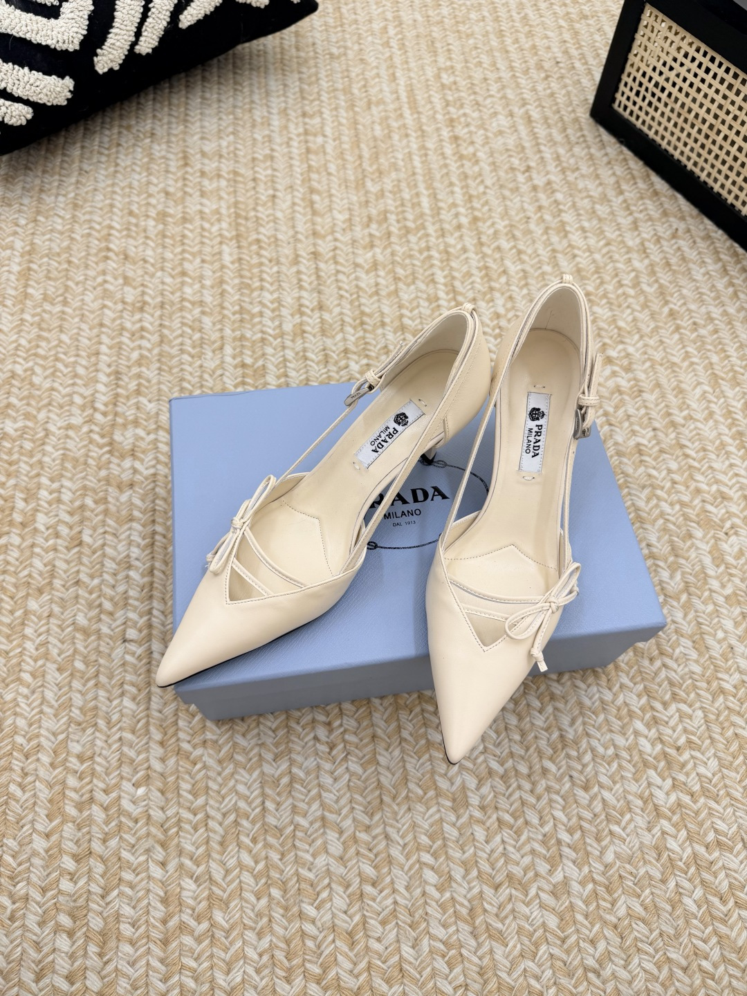 NO:927021,Prada 26/ Latest catwalk pointed toe bow high heels, buckled side hollow stiletto heels, retro old money style kitten heels, minimalist beauty that has been missing for a long time in the fashion industry, fashionable and sophisticated, giving a high-end feel for daily wear  Strong lines and bold details transform the high-heeled shoes that symbolize femininity into a unique and non-traditional design. The pointed-toe silhouette is made of cow leather, with obvious stitching and intentionally unfinished raw cutting edges. The exquisite stiletto heels perfectly present the multi-faceted style of this shoe. Made of high-quality leather material, the texture is high-end, showing a retro and modern texture, and the craftsmanship is fine, reflecting the brand's high-end quality. The stiletto heel design enhances the wearer's aura while maintaining good stability, suitable for daily commuting or special occasions.  Upper cow patent leather/calf leather, lining sheepskin, heel height 5.5/7.5cm, Italian genuine leather outsole Size#35-41 (40.41 custom-made, non-refundable), high-heeled shoes, prada, prada, high heels, cowhide, sheepskin, Leather soles19860909Prada 普拉达 26/ 最新走秀款尖头蝴蝶结高跟鞋 搭扣侧空细跟单鞋 复古老钱风小猫跟 单鞋 时尚界久违的极简之美 时髦又精致 日常穿出高级感 强烈的线条和大胆的细节将象征女性魅力的高跟鞋转变为独特而非传统的设计.尖头廓形采用牛皮革,具有明显的缝线和故意未完成的原始切割边缘.精致的细高跟完美呈现出此款鞋履的多面风格. 选用优质皮革材质,质感高级,呈现出复古又摩登的质感,工艺精细,体现品牌高端品质.细高跟设计,提升穿着者气场,同时保持了较好的稳定性,适合日常通勤或特殊场合穿着. 鞋面牛漆皮/小牛皮 内里羊皮 跟高5.5/7.5cm 鞋底意大利真皮大底 Size#35-41（40.41定做不退换）,高跟鞋单鞋,prada,prada,high heels,cowhide,sheepskin,Leather soles,Women's Shoes