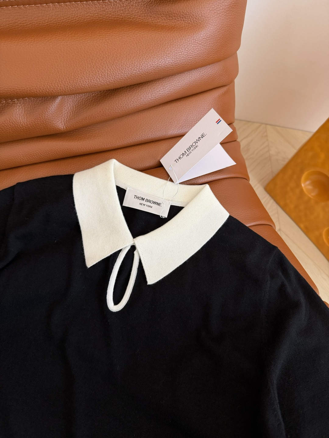 26春夏 镂空水滴形状设计针织上衣 经典的黑白撞色真的百穿不厌 下摆双侧加入了经典织带的拼接开叉设计 很