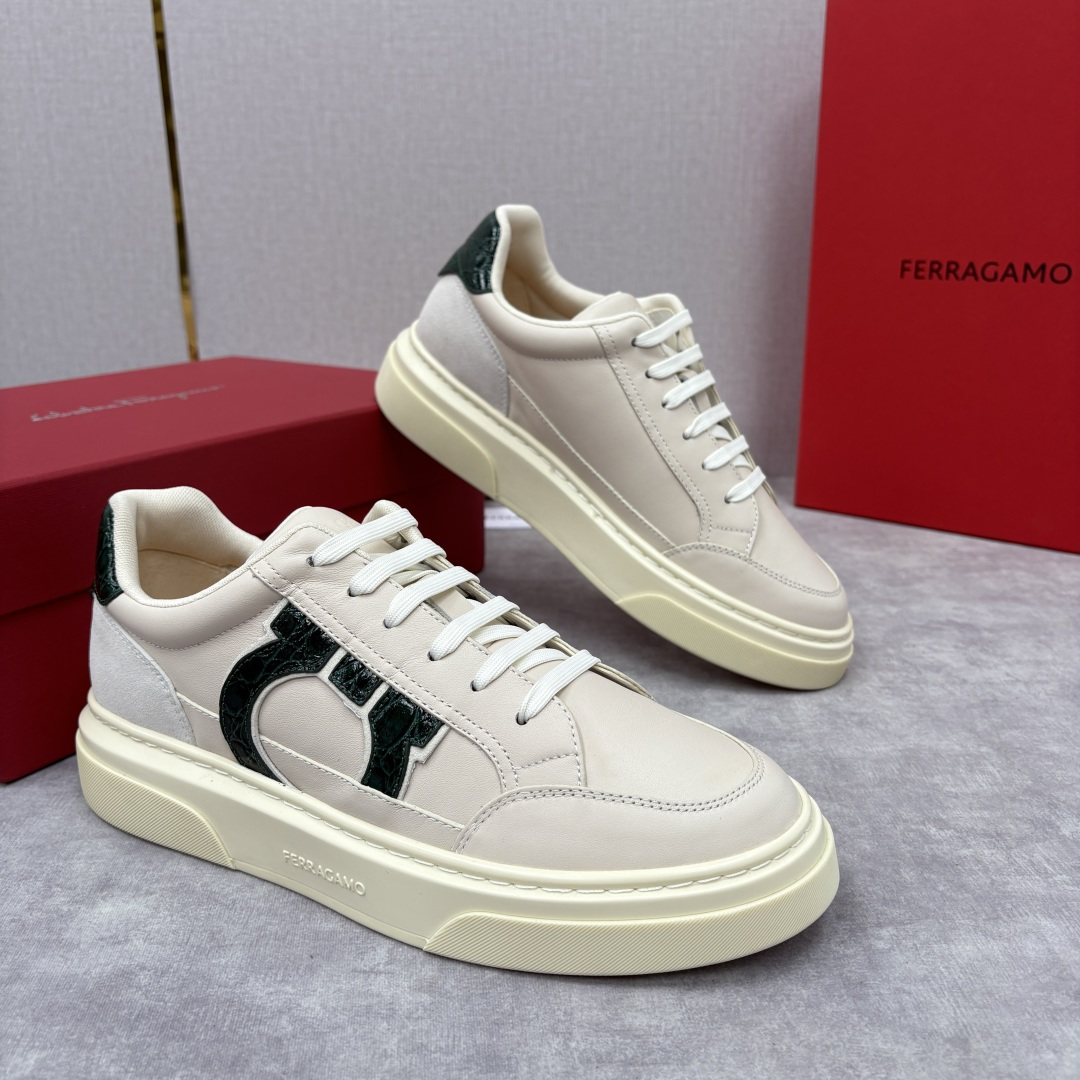 NO:589785,Ferragamo's new casual sneakers with special-shaped inlays. These casual shoes have a low-key style, and are designed with multiple elements and contrasting colors. They are made of imported cowhide with same-color/contrast-color cowhide splicing. The special-shaped inlays are inspired by the hollow shape of the leather goods series. The three-dimensional Gancini symbol is displayed on a large area on the shoe body. Some styles are superimposed with crocodile pattern embossing and contrasting strokes, making the classic logo break out of monotony and bring recognition!  The contrasting color logo is calm and reveals the ingenuity of the details. It is paired with a soft sports cloth lining, taking into account both high-end touch and foot comfort; the elegant style and casual charm complement the low-top sneaker silhouette + thick sole design, which not only retains the casualness of casual shoes, but also enhances the sophistication through the layered splicing of the heel and shoe side. The thick sole is decorated with customized grooves, making it more unique. With the brand's iconic double G logo as the core, the luxury texture is blended into daily wear (^_-)  Size39-44 (customized at 38.45),,ferragamo,ferragamo,cowhide19860909Ferragamo 菲拉格慕新款异型嵌饰休闲鞋板鞋 这款休闲鞋风格低调,多元素拼接撞色设计搭配选用进口牛皮配以同色/撞色牛皮拼接.异形嵌饰灵感源自皮具系列的镂空造型, 鞋身大面积呈现立体Gancini符号,部分款式叠加鳄鱼纹压花、撞色描边,让经典Logo跳出单调,自带辨识度！撞色标识沉稳中透出细节巧思.搭配柔软运动布内衬,兼顾高级触感与脚感舒适度；高雅风格与休闲气韵交相辉映低帮板鞋轮廓+厚底设计,既保留休闲鞋的随性,又通过鞋跟、鞋侧的层次拼接提升精致度. 厚底饰有定制沟纹,愈显别致.以品牌标志性双G标识为核心,把奢华质感揉进日常穿搭里(^_-) Size39-44（38.45定做）,,ferragamo,ferragamo,cowhide,Men's shoes