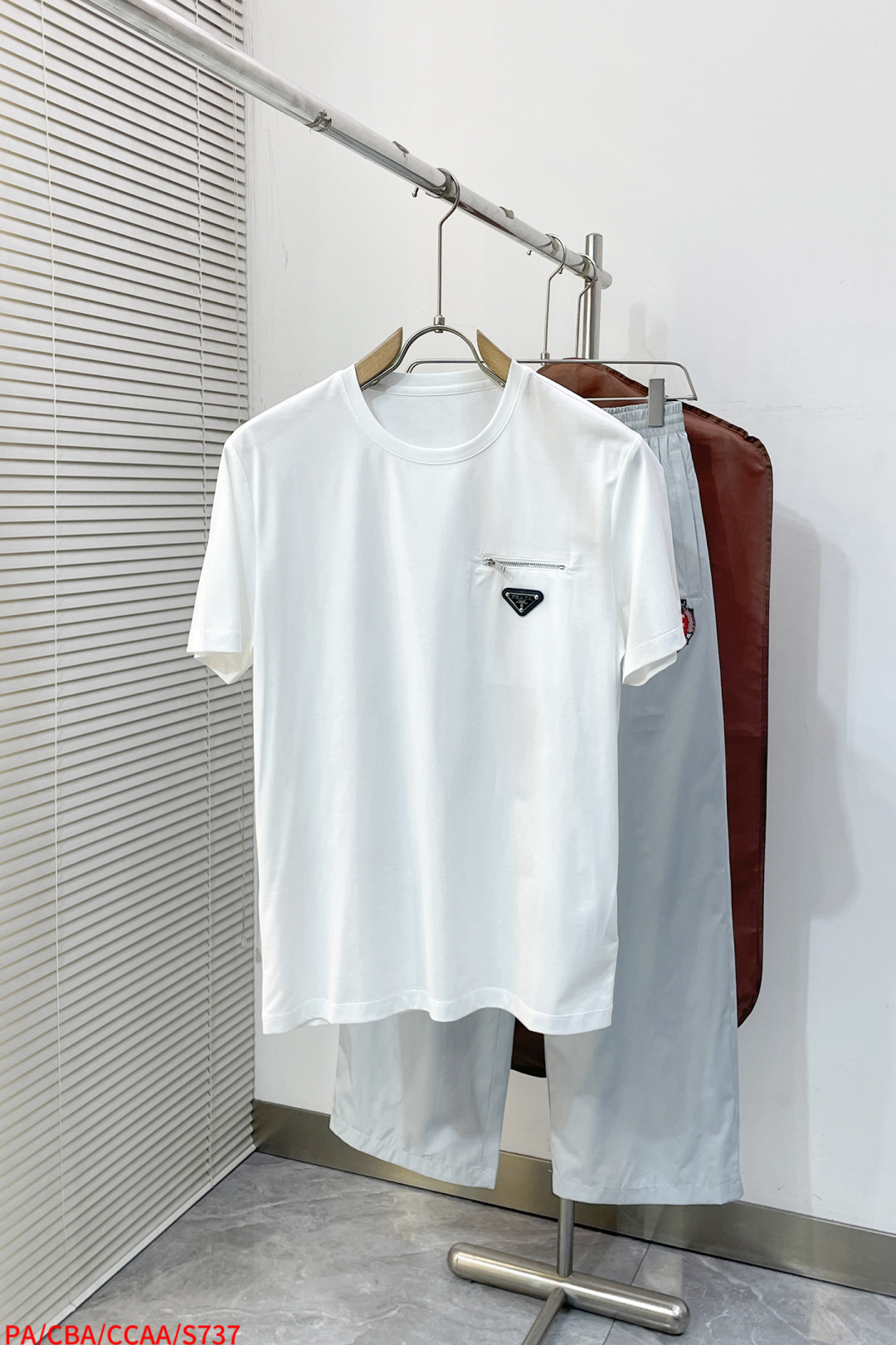 NO:734465,S737 PA Prada 2026 Spring and Summer Annual Classic Nylon splicing design mercerized cotton round neck T-shirt, nylon splicing design. The zipper pocket on the chest is embellished with a triangle logo. You can feel the theme on the upper body, which brings a sense of youth and fashion. Fitted tailoring, the collar slightly fits the neck, making the overall upper body more youthful and fashionable. Before cutting, the fabric is strictly in accordance with the standards of 5 washes before dyeing, and the shrinkage rate is controlled within 2.  The fabric is made of custom-woven high-weight pure cotton, treated with mercerization process. The surface has a warm luster, the upper body is comfortable and smooth, and looks high-end. It is skin-friendly, breathable, and has a good stiff feeling. Color: black, white. Size: M-3XL, prada, tees, t-shirt,19860909S737 PA 普拉达 2026春夏 年年经典 尼龙拼接设计丝光棉圆领T恤衫,尼龙拼接的设计 胸口拉链口袋结合三角标点缀 上身就能体会主题带来年轻与时尚感 合体的的剪裁,领口微微贴合颈部,让整体上身更显年轻时尚 ,面料在裁剪前,严格按照染色前5次 洗水的标准, 将缩水率控制在2内, 面料采用客供定织高克重纯棉质地,丝光工艺处理 表面有着温润的光泽感,上身舒适顺滑,显高档 亲肤 透气,又有很好挺括感 颜色 黑色 白色 码数M-3XL,,prada,tees，t-shirt,,Men's clothing