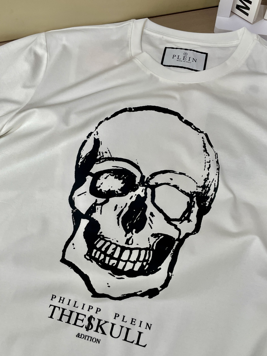 “Philip Planan’s Skull Signature T-Shirt: Custom Fabric, Unique Design, Metal Logo Card” - 图片 6