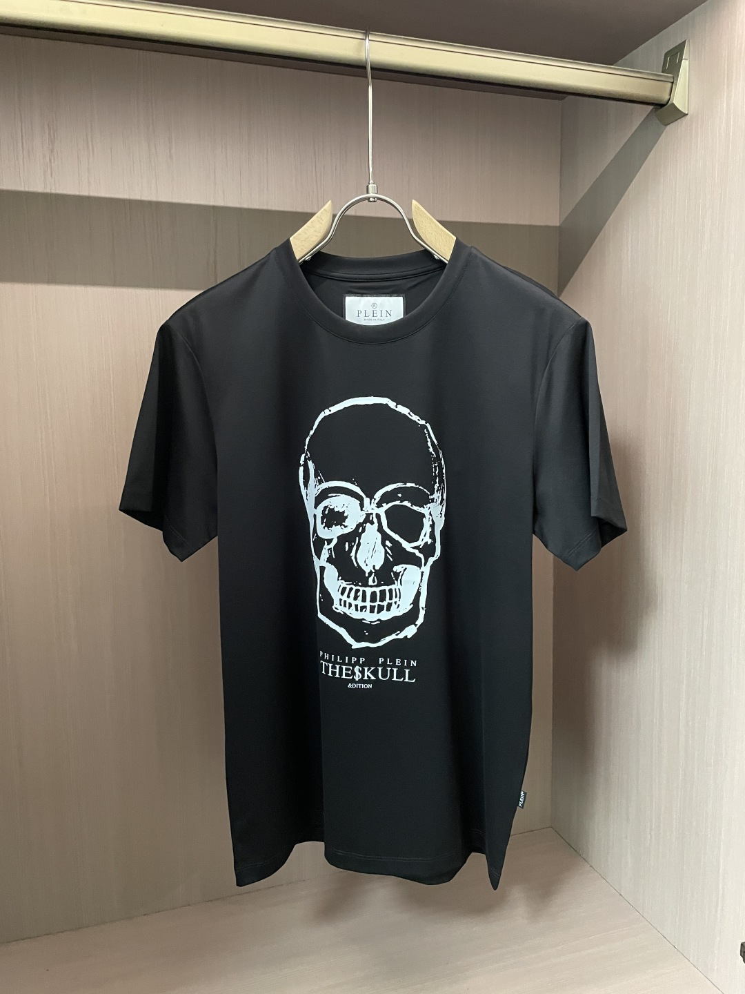 “Philip Planan’s Skull Signature T-Shirt: Custom Fabric, Unique Design, Metal Logo Card”